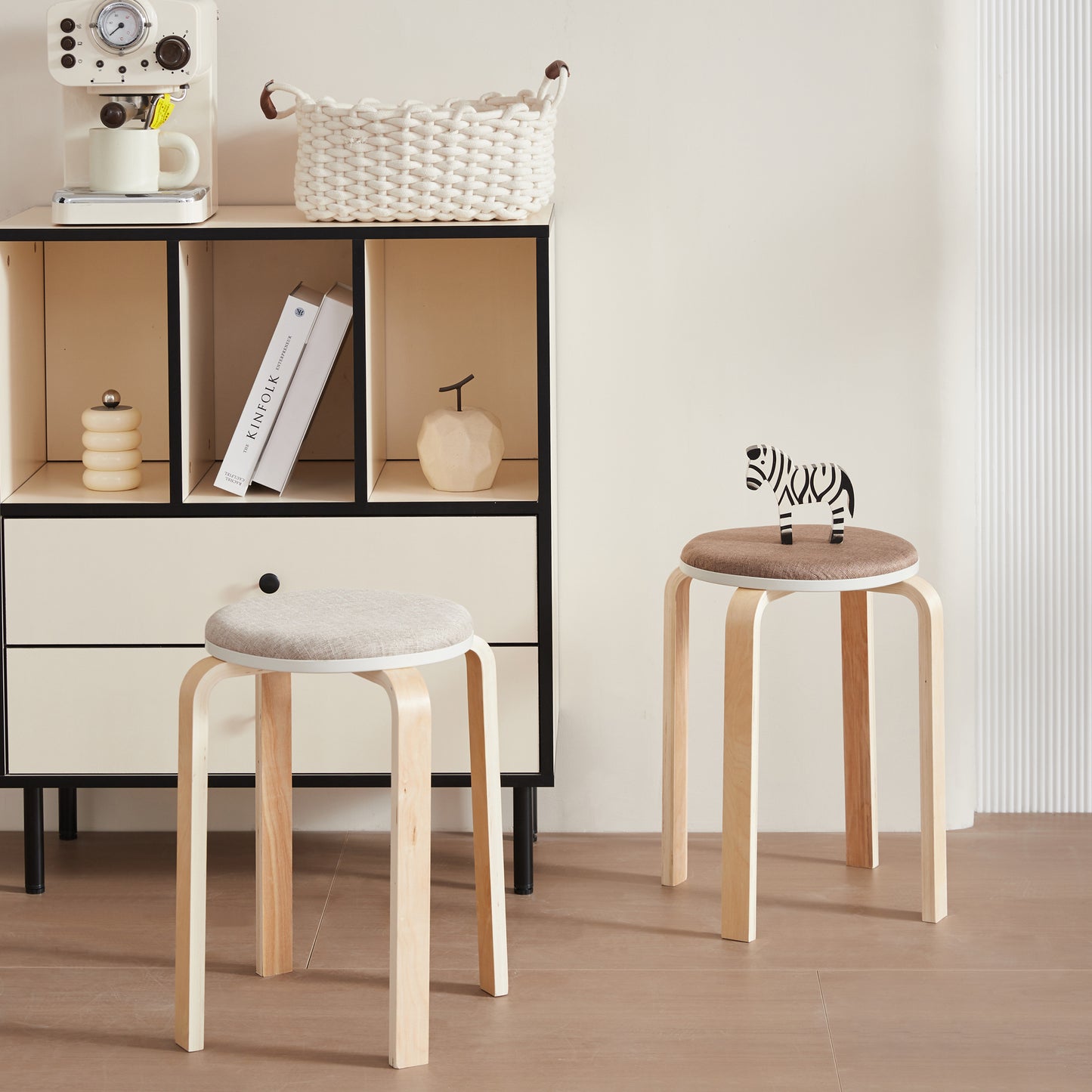 Light wood stool with a round grey linen seat and black knob