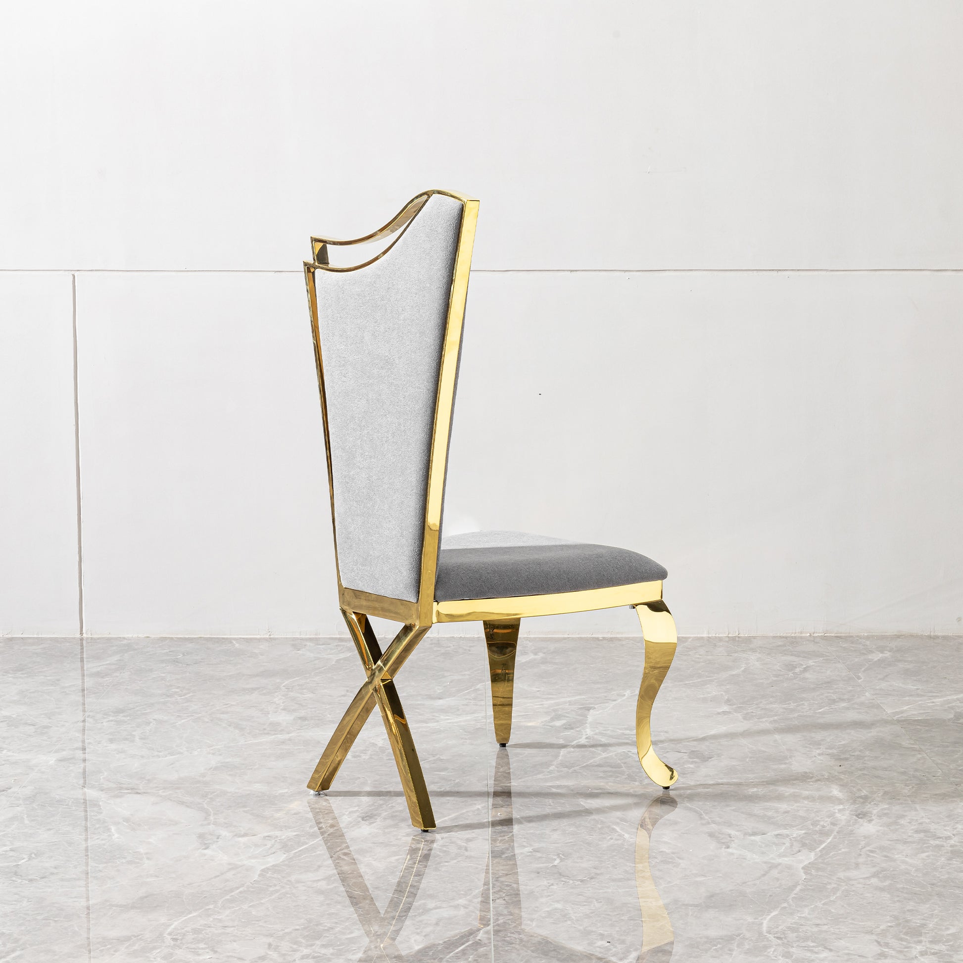 Elegant grey upholstered dining chair with polished gold metal frame
