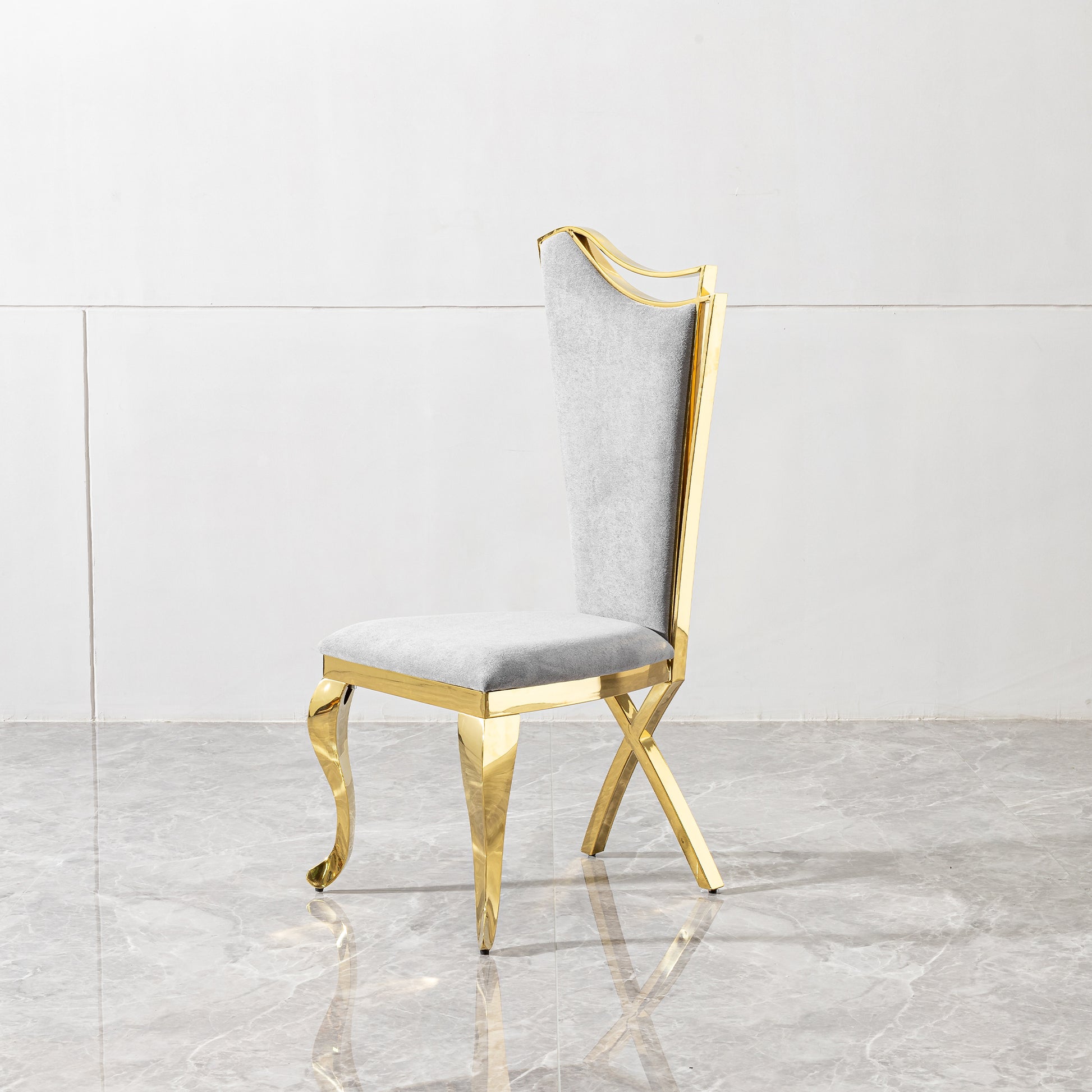 Elegant grey upholstered dining chair with polished gold frame and decorative legs
