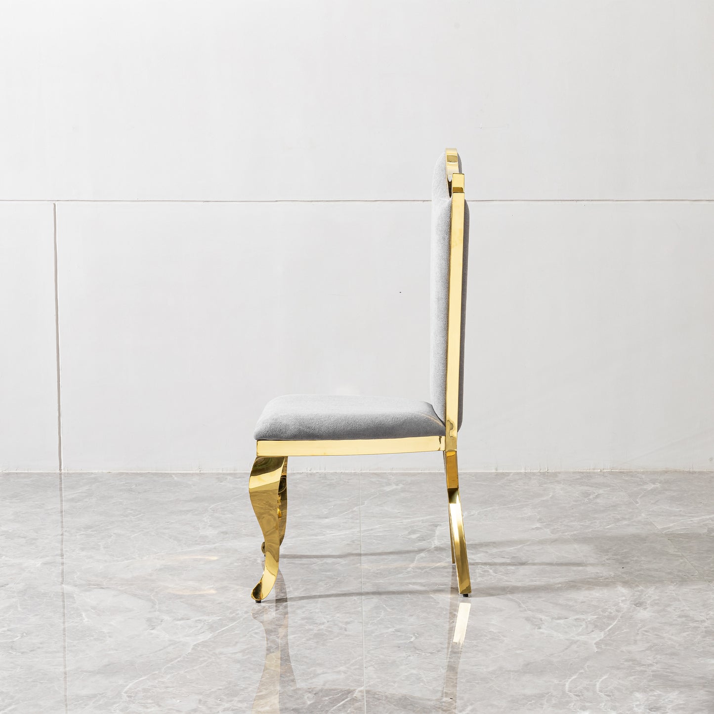 Elegant grey upholstered dining chair with ornate gold metal legs