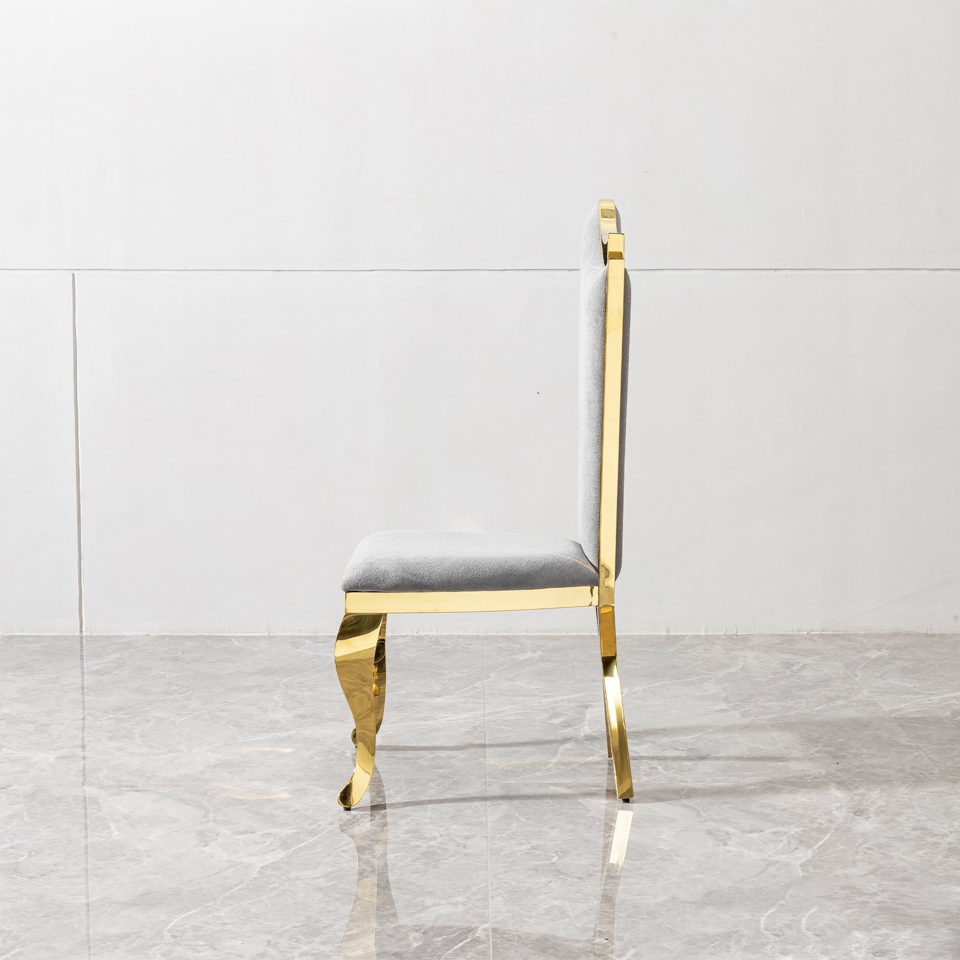 Elegant grey upholstered dining chair with ornate gold metal legs