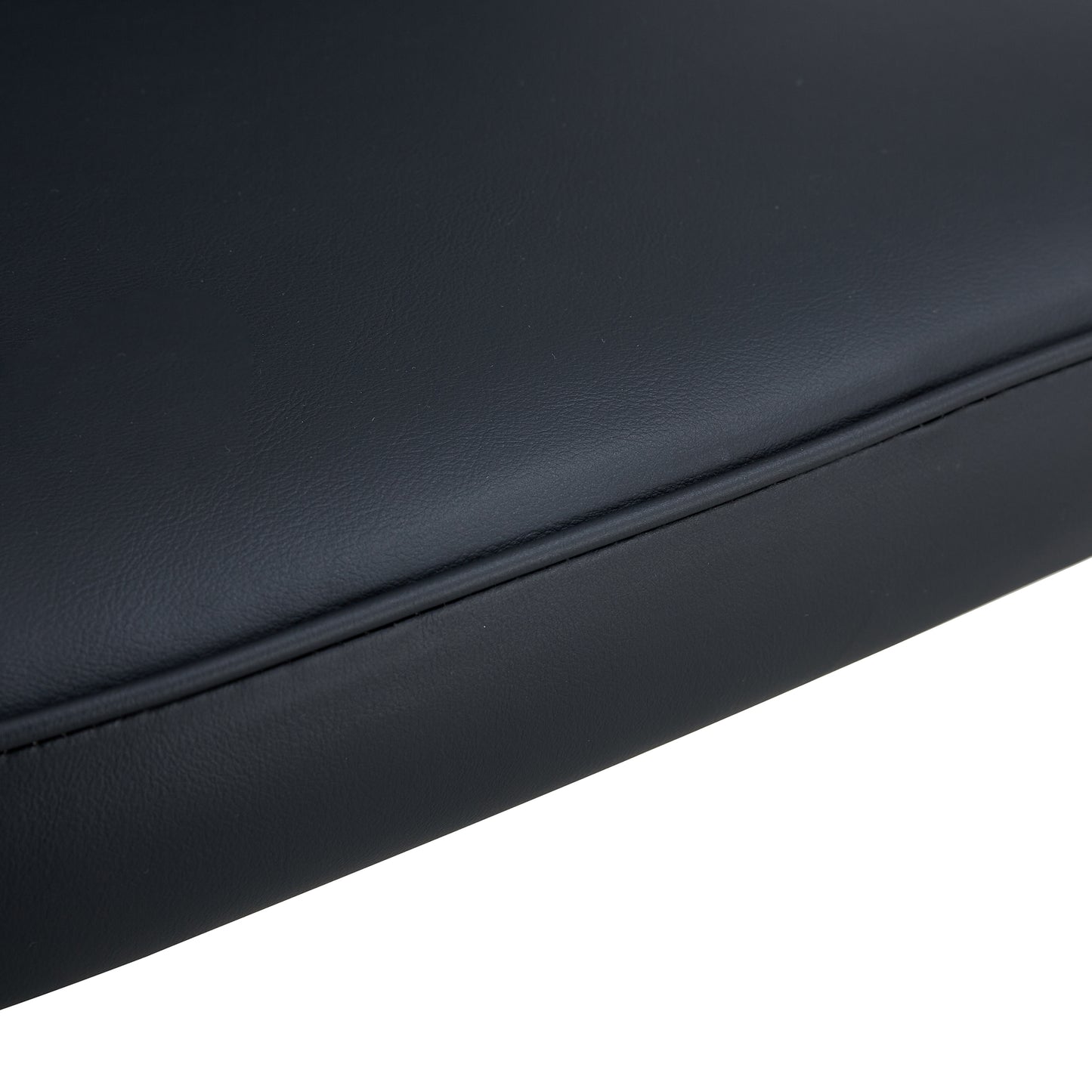 Closeup of black faux leather upholstery with stitched detailing