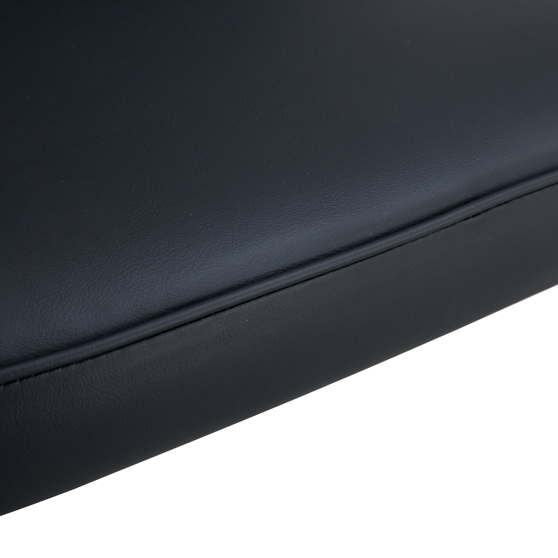 Closeup of black faux leather upholstery with stitched detailing