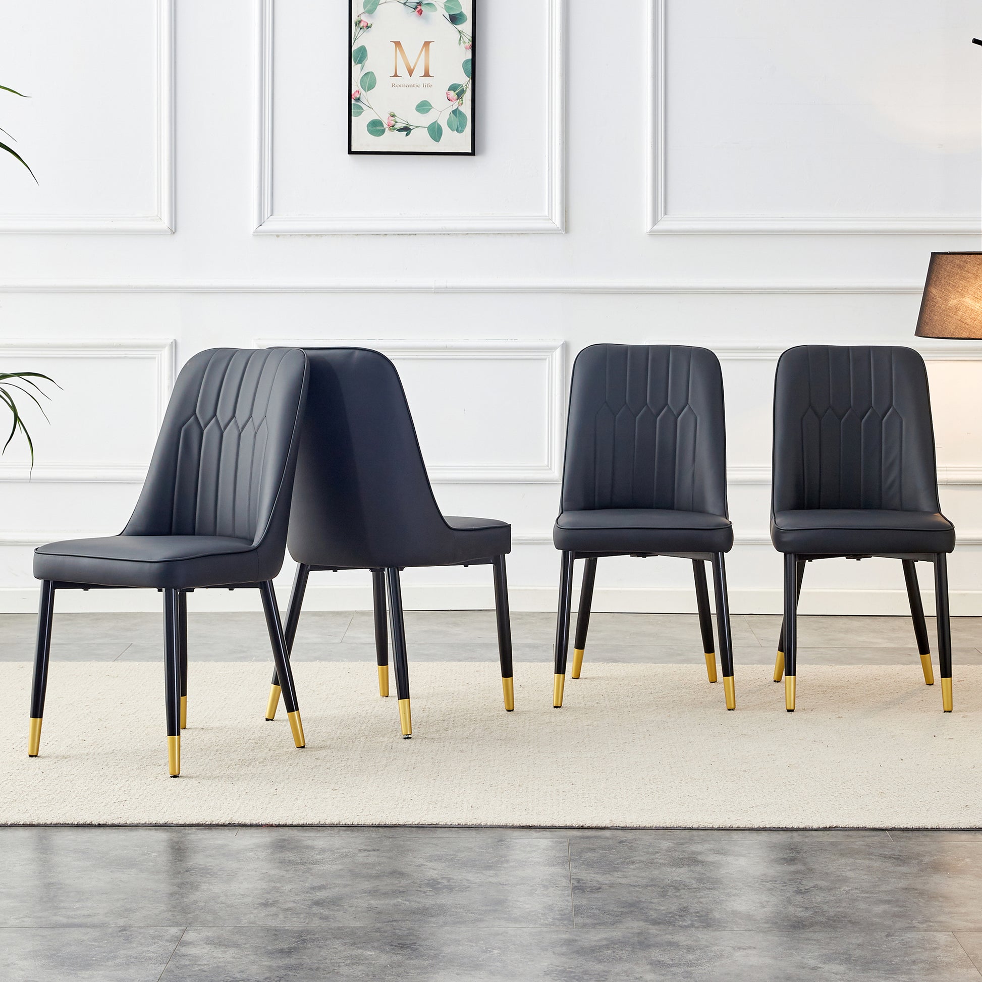 Black upholstered dining chair with tufted back and goldtipped legs