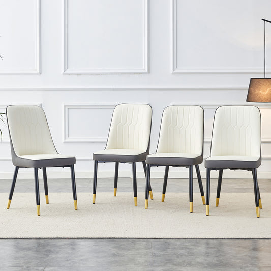 Four cream and gray upholstered dining chairs with goldtipped black legs