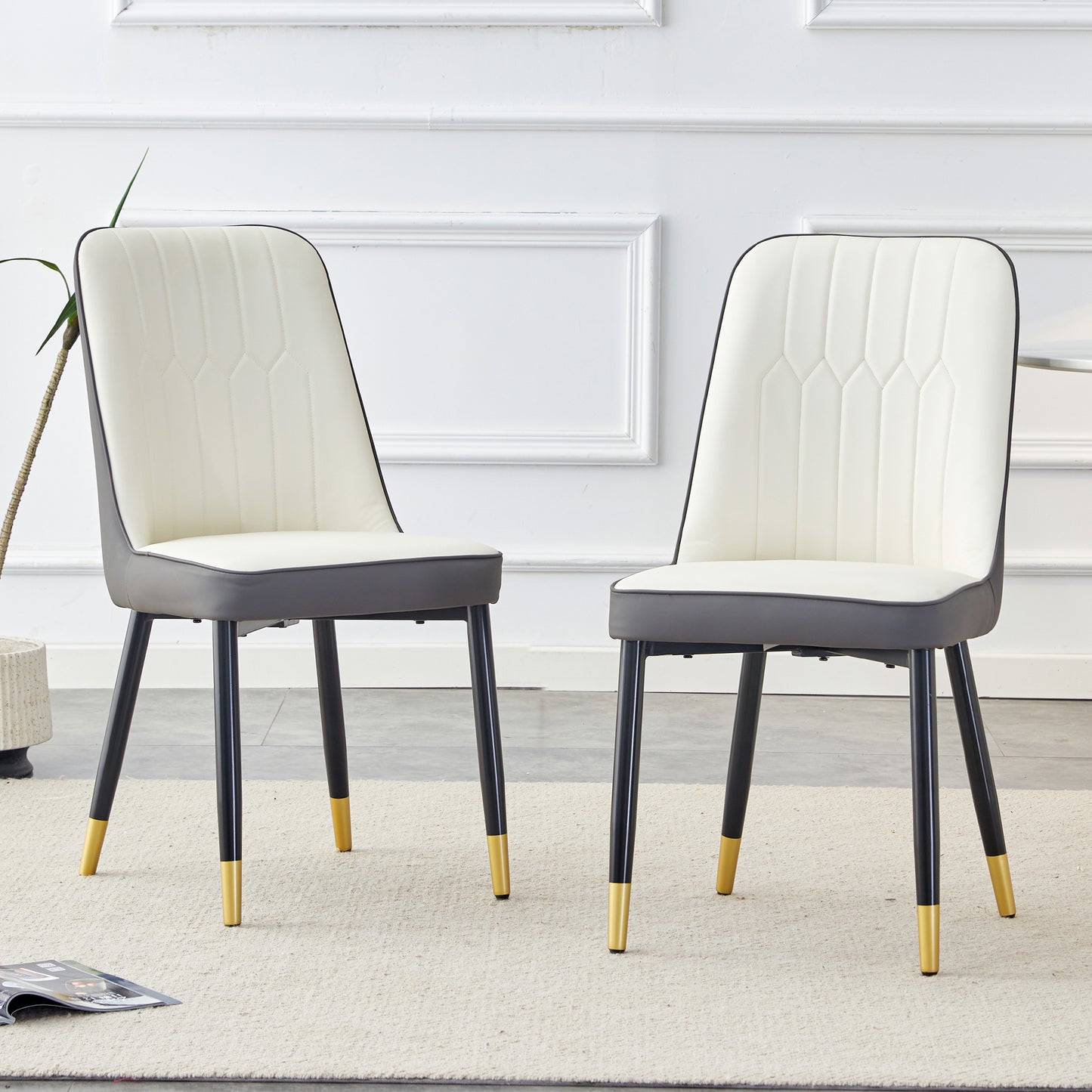 Cream upholstered dining chair with dark gray seat and goldtipped legs