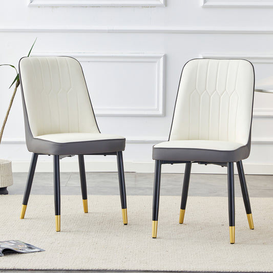 Cream upholstered dining chair with dark gray seat and goldtipped legs