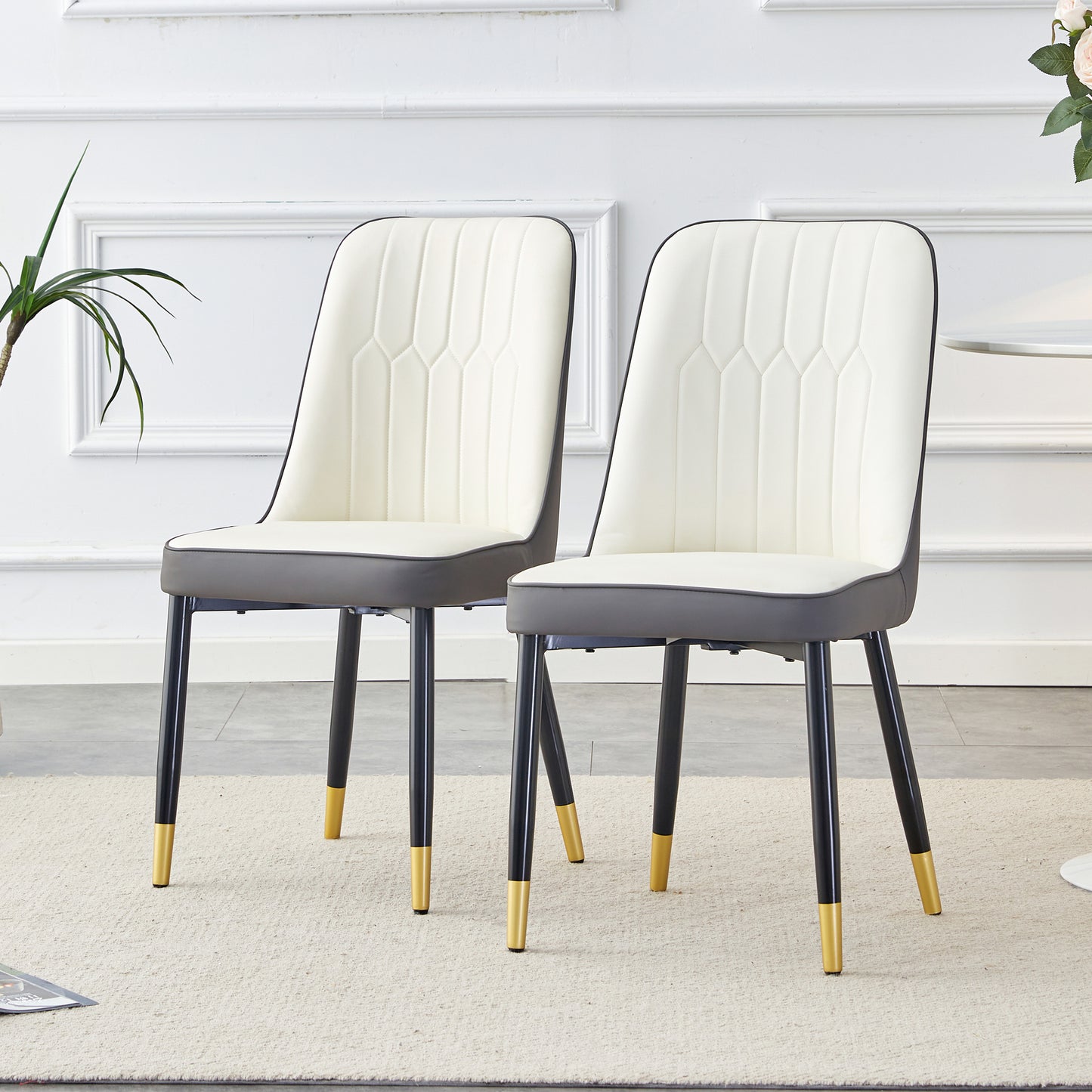 Cream upholstered dining chair with dark gray seat and goldtipped black legs