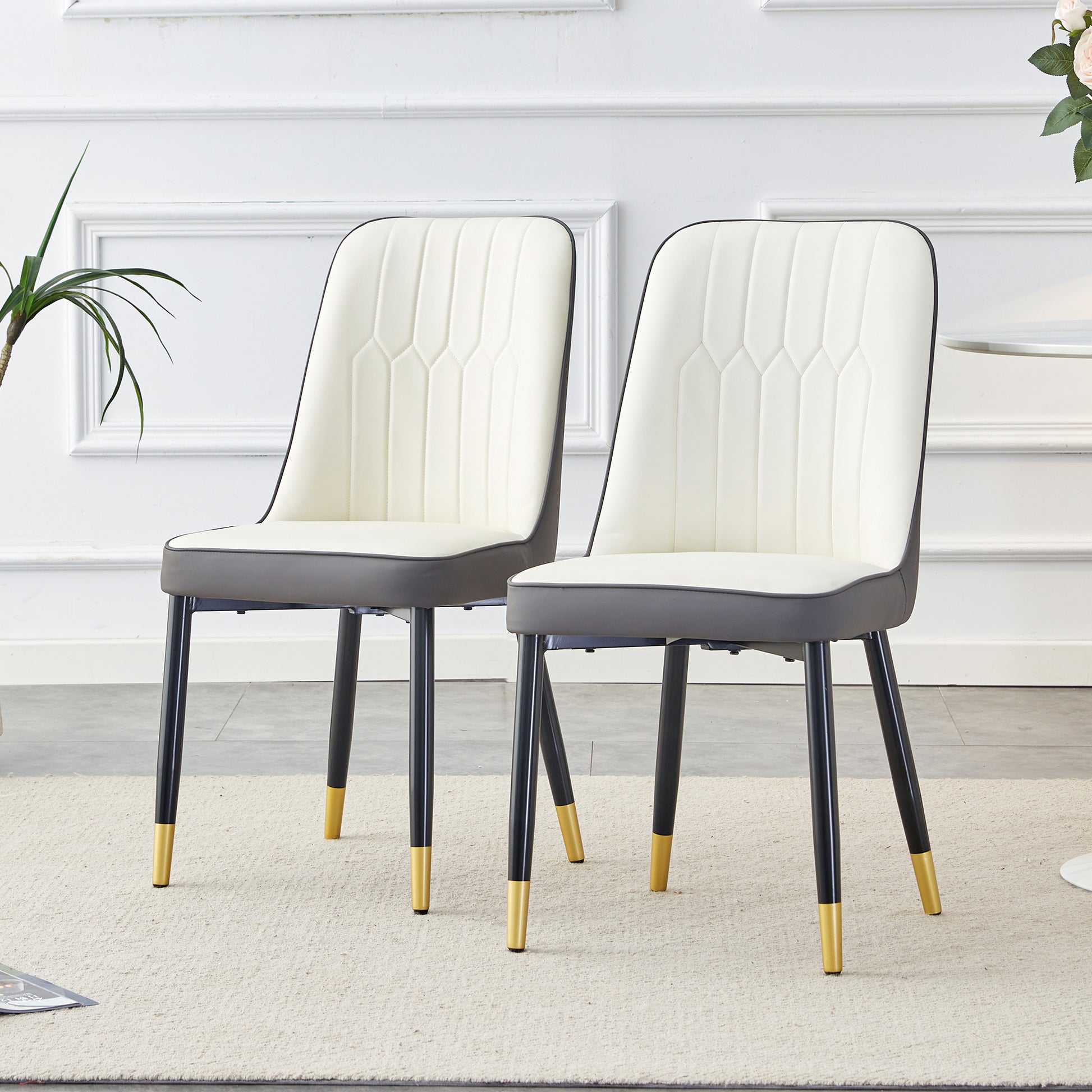 Cream upholstered dining chair with dark gray seat and goldtipped black legs