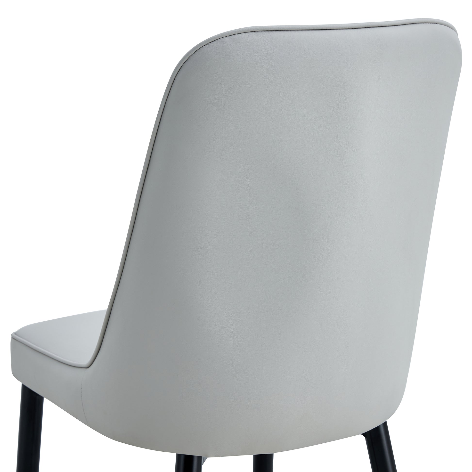 Light gray faux leather dining chair with curved back