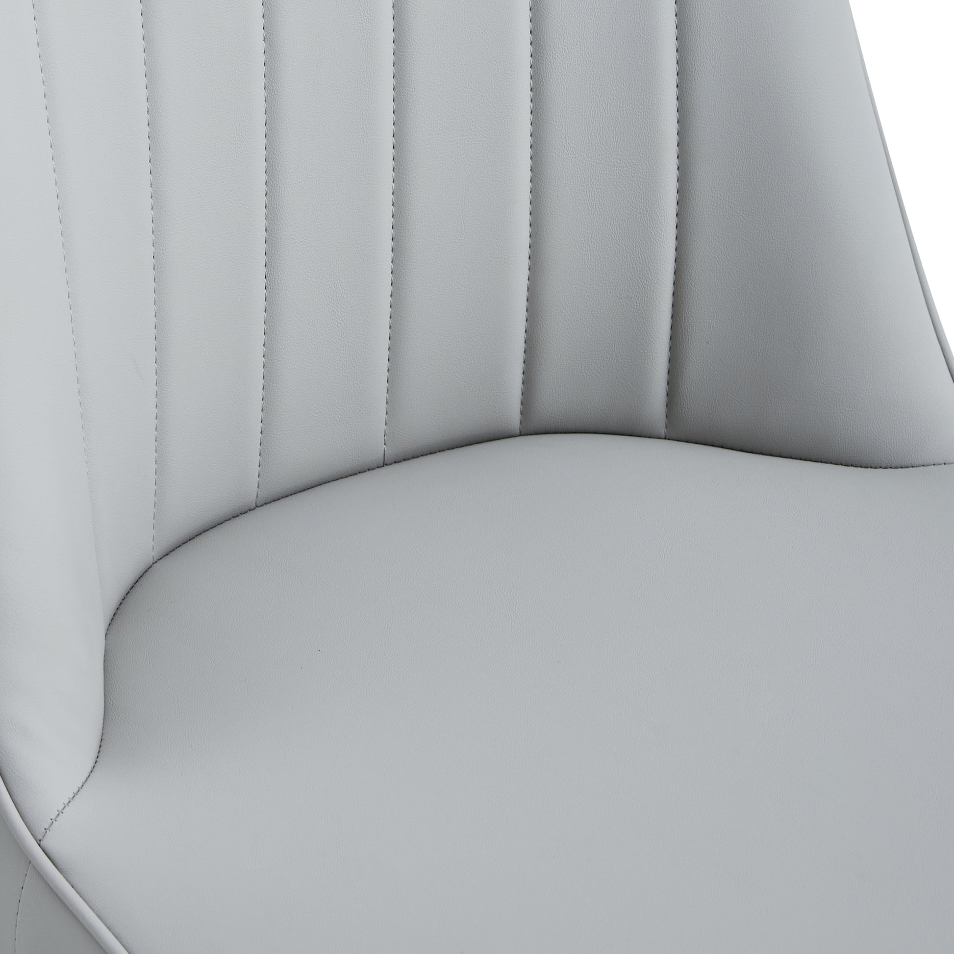 Closeup of light grey faux leather dining chair seat with channel tufting
