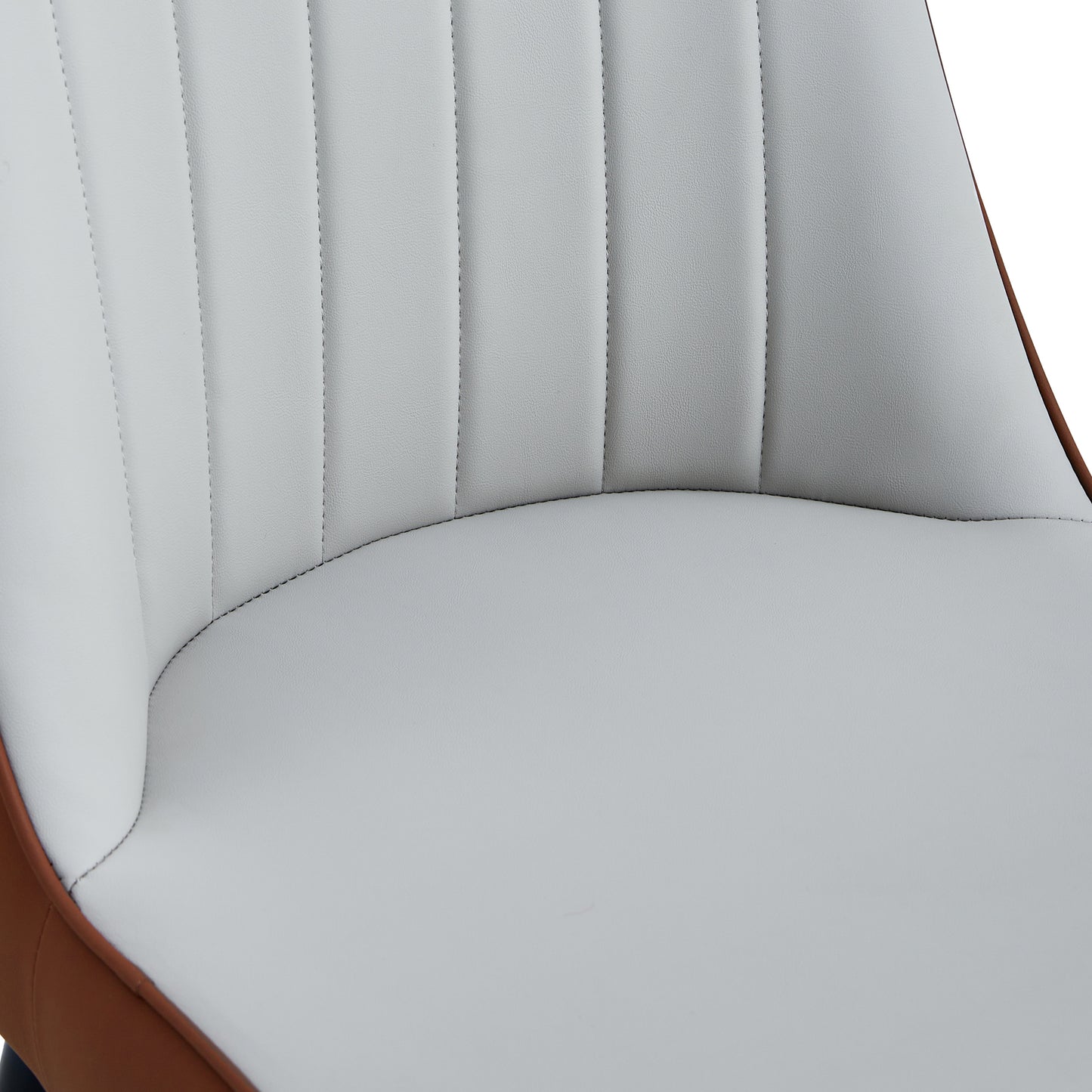 Close up of a white upholstered dining chair with vertical stitching