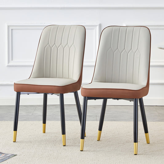 Cream and tan upholstered dining chair with stitched detailing and goldtipped black legs