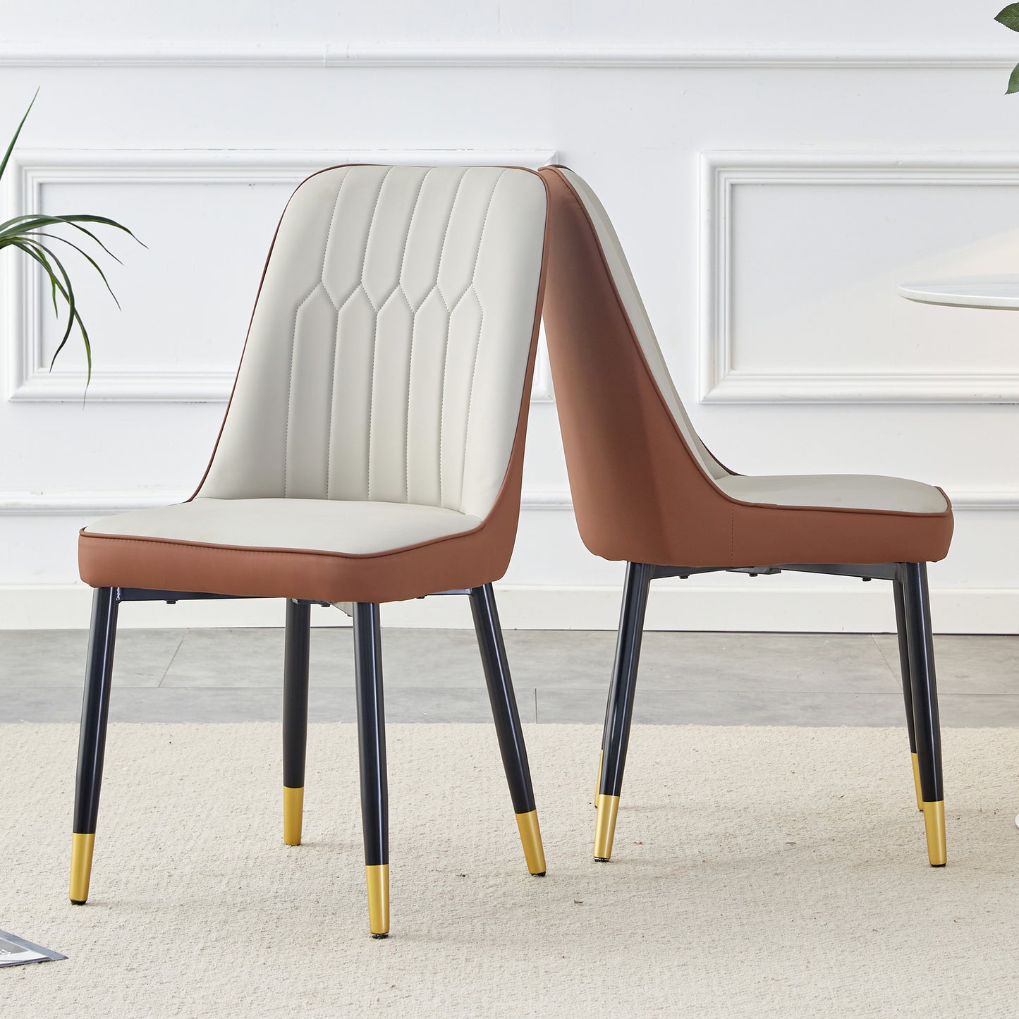 Modern dining chairs with cream upholstery and brown faux leather trim