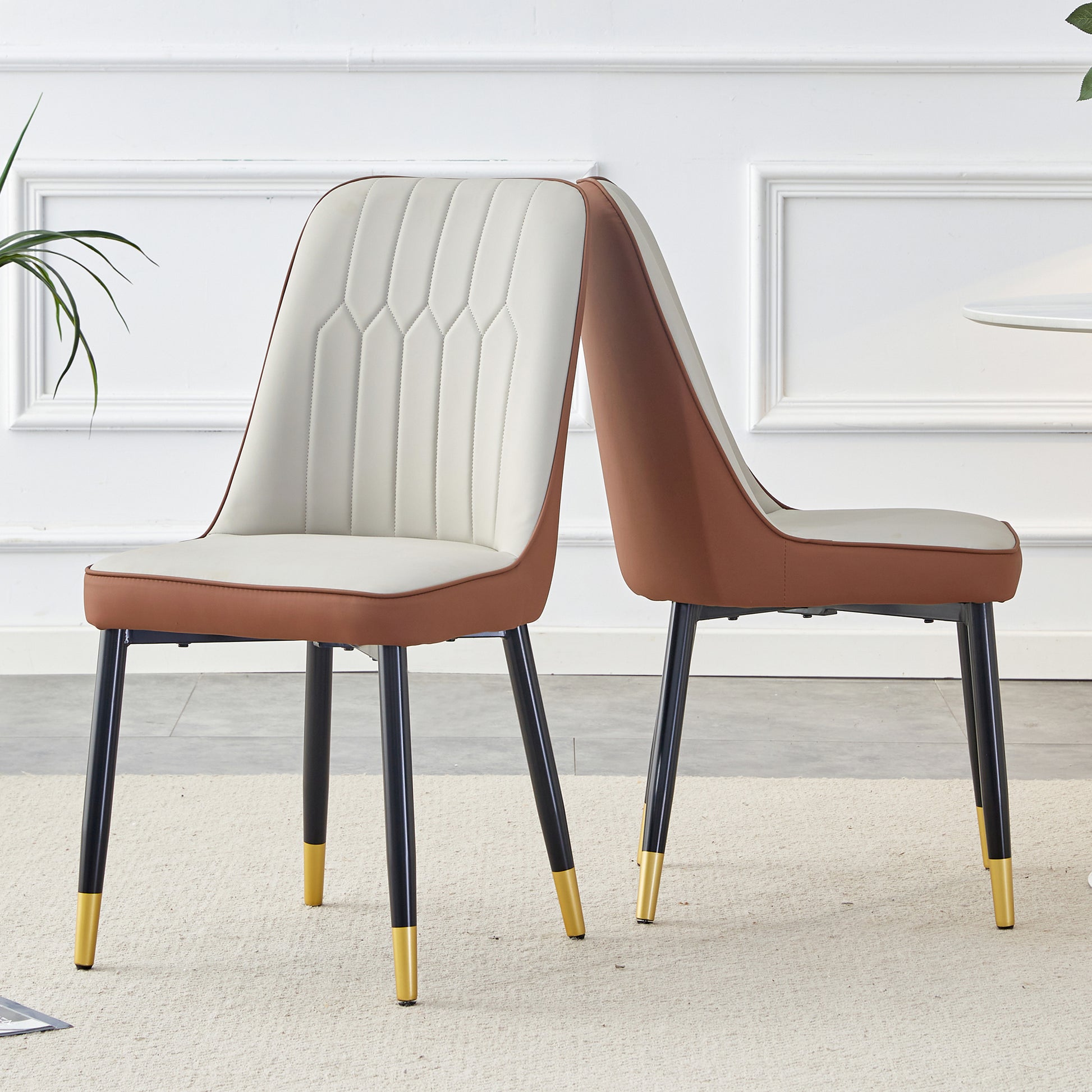 Modern dining chairs with cream upholstery and brown faux leather trim