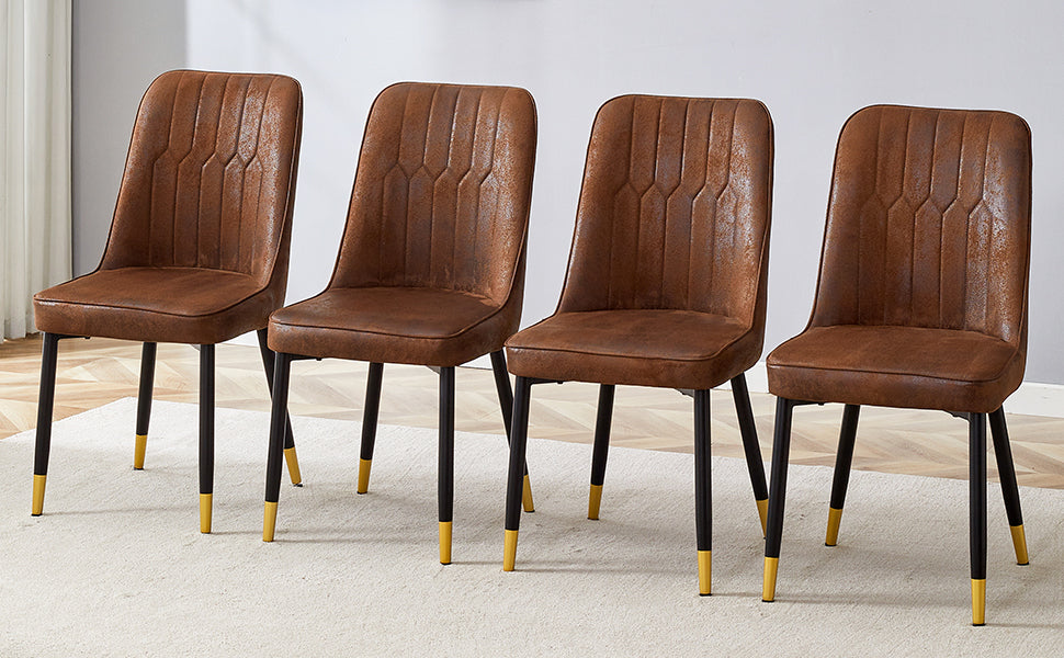 Four brown faux leather dining chairs with black legs and gold accents