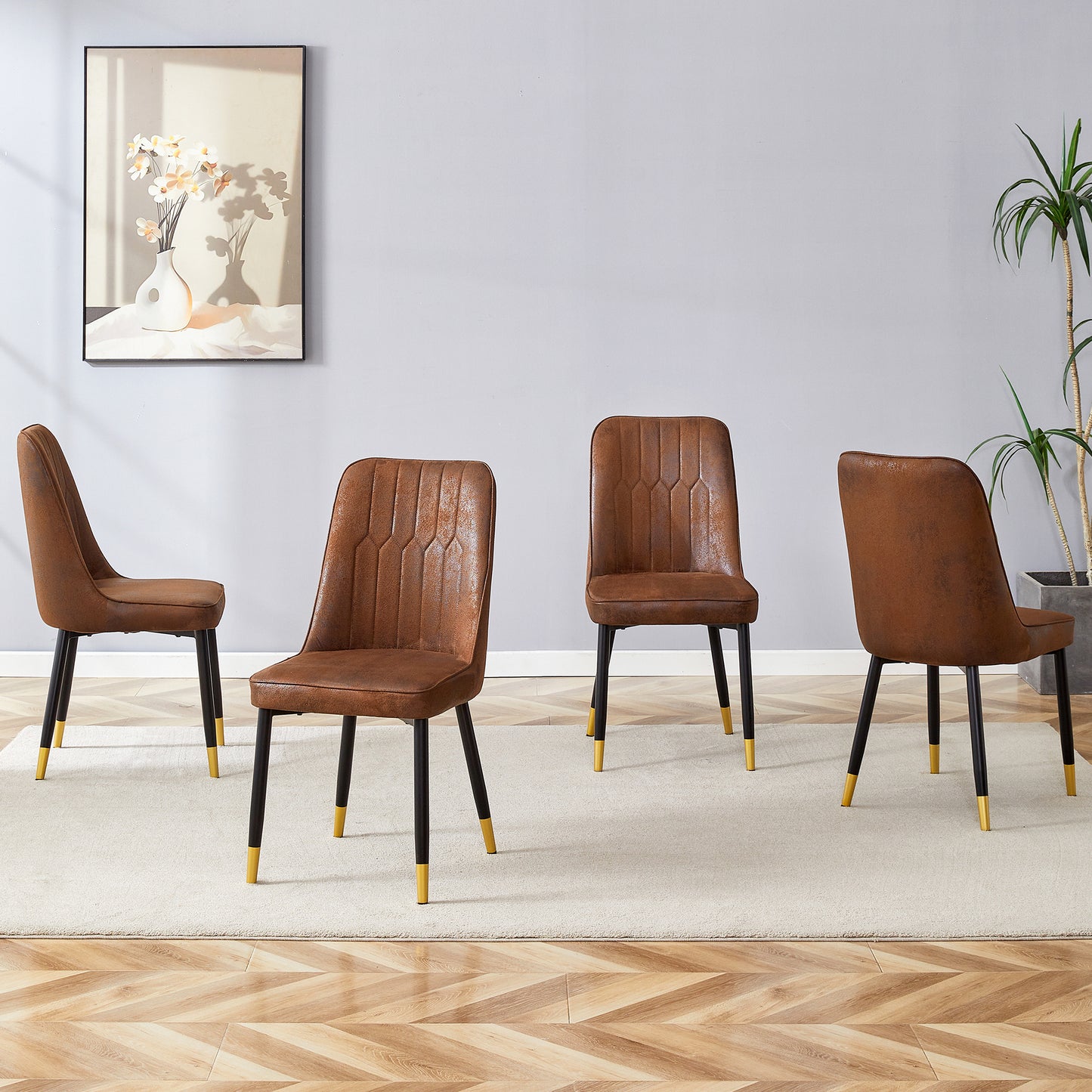 Set of four brown faux leather dining chairs with black legs and gold accents