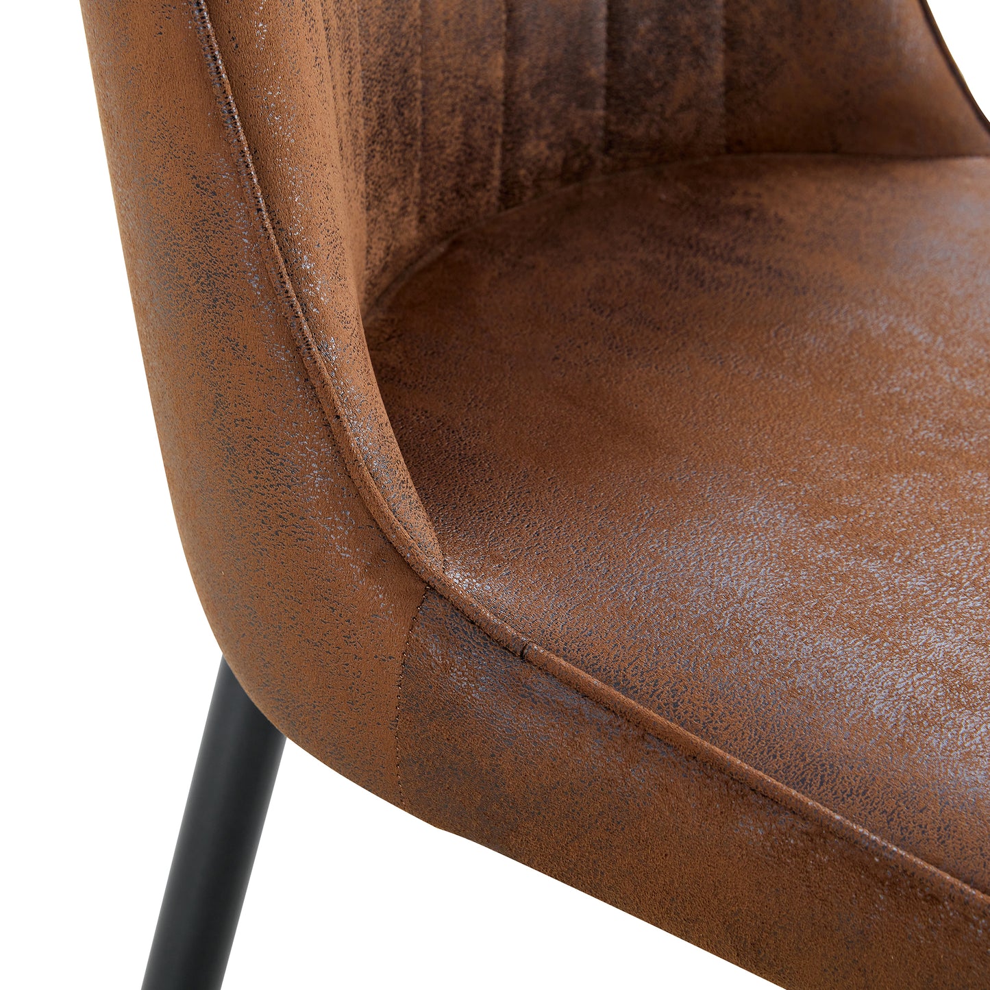 Closeup of distressed brown faux leather dining chair with black metal legs