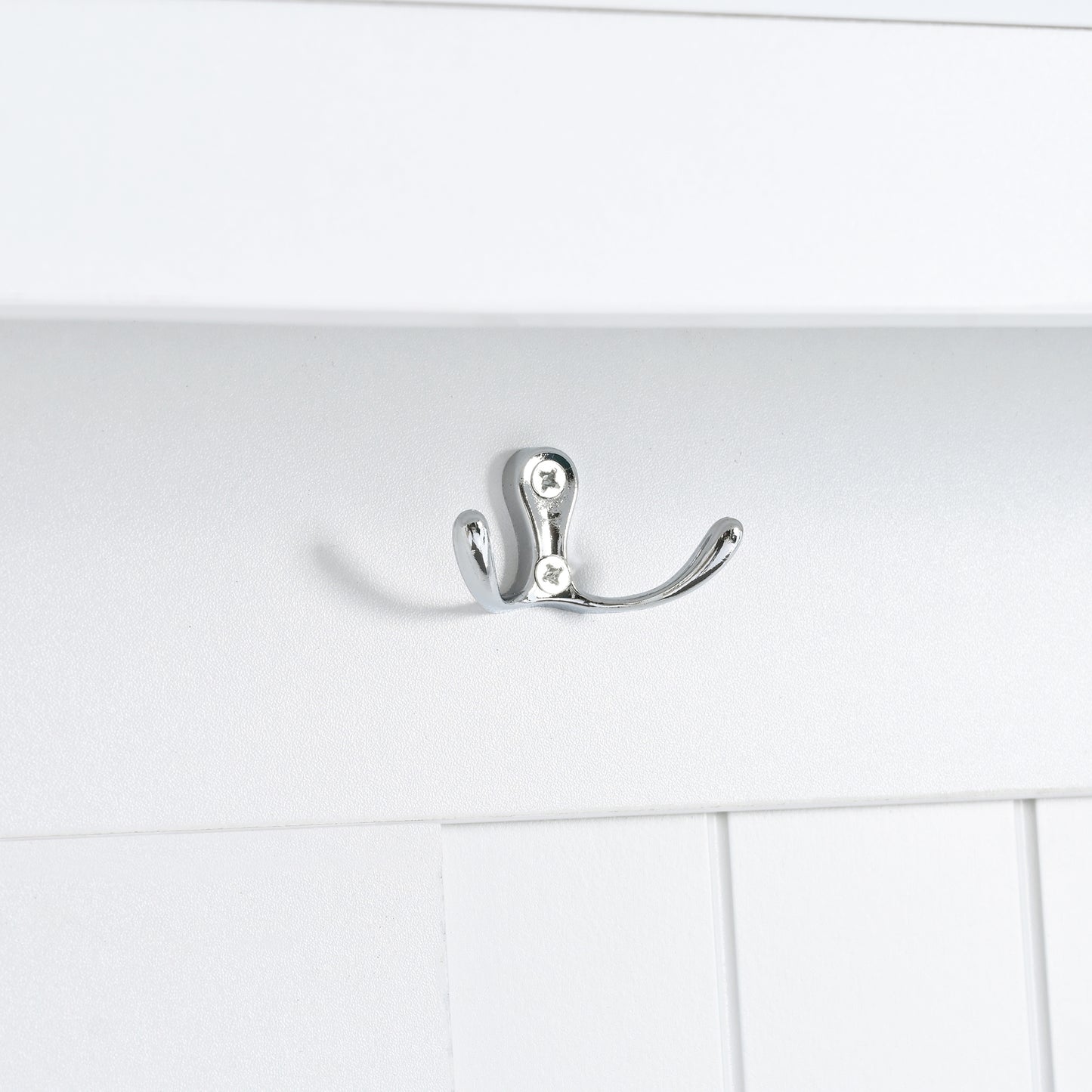 Doublepronged chrome coat hook mounted on white paneling