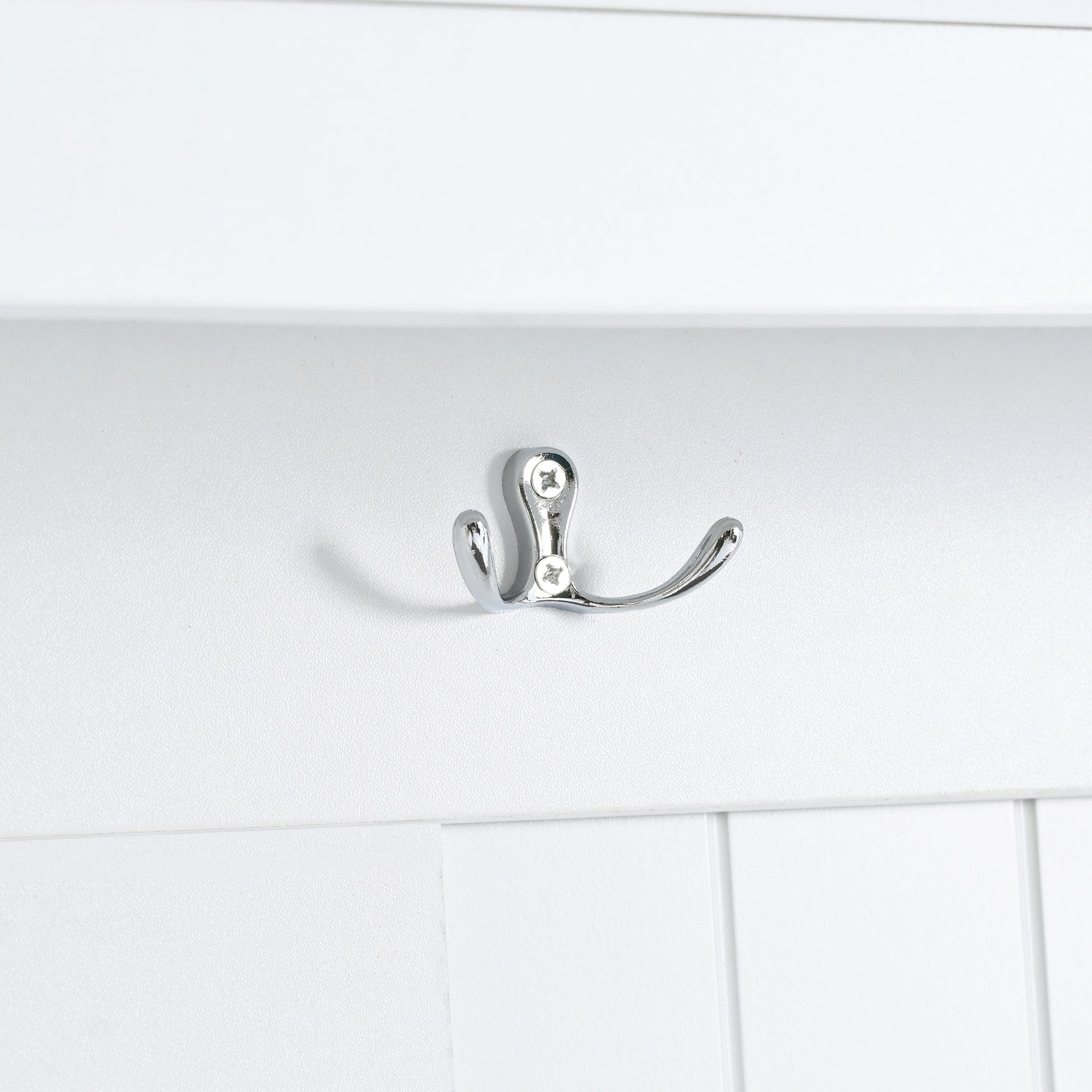 Doublepronged chrome coat hook mounted on white paneling