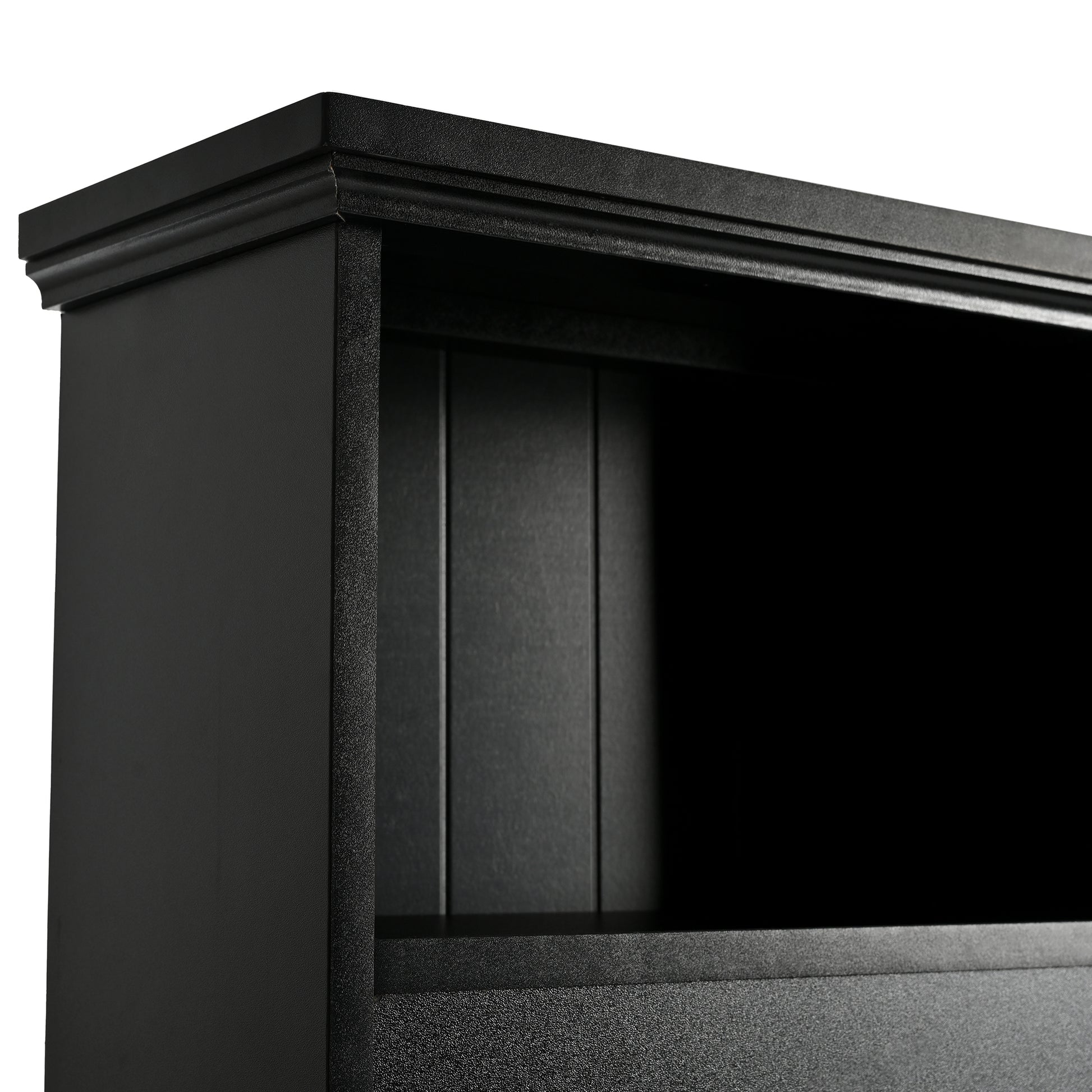 Black wooden bookcase detail with ornate top molding and paneled back