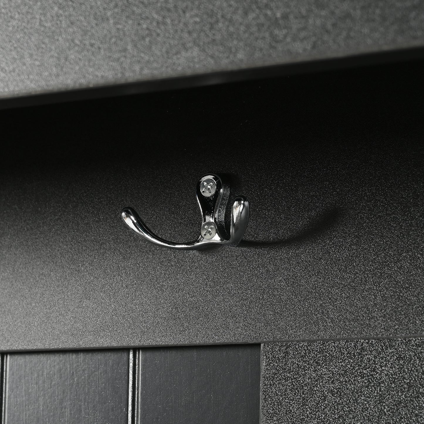 Chrome double hook mounted on textured black panel