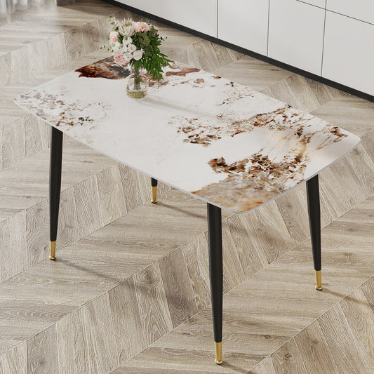 Rectangular dining table with white and brown marblepatterned top and black legs with gold accents