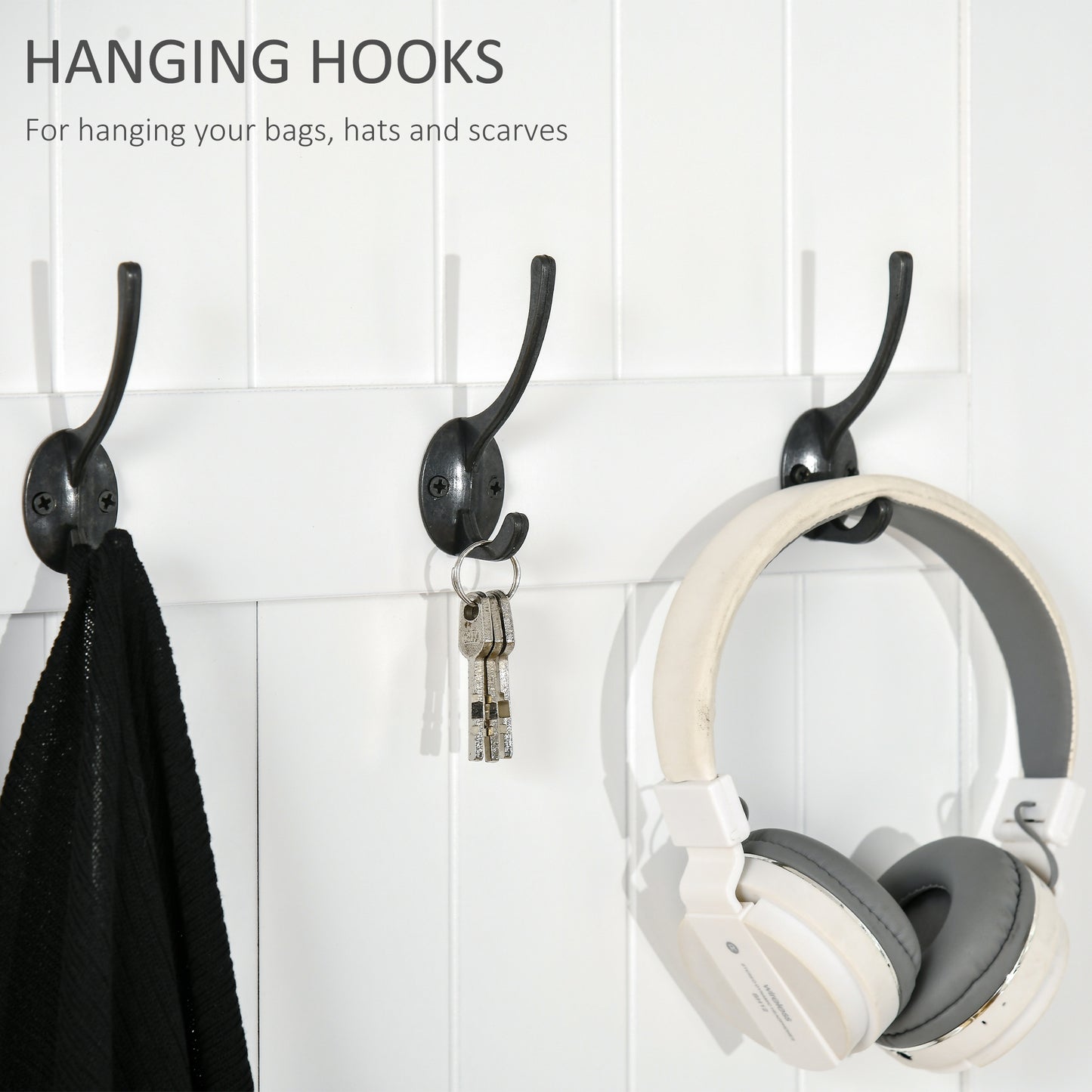 Three dark metal hanging hooks mounted on white beadboard wall holding a scarf keys and headphones