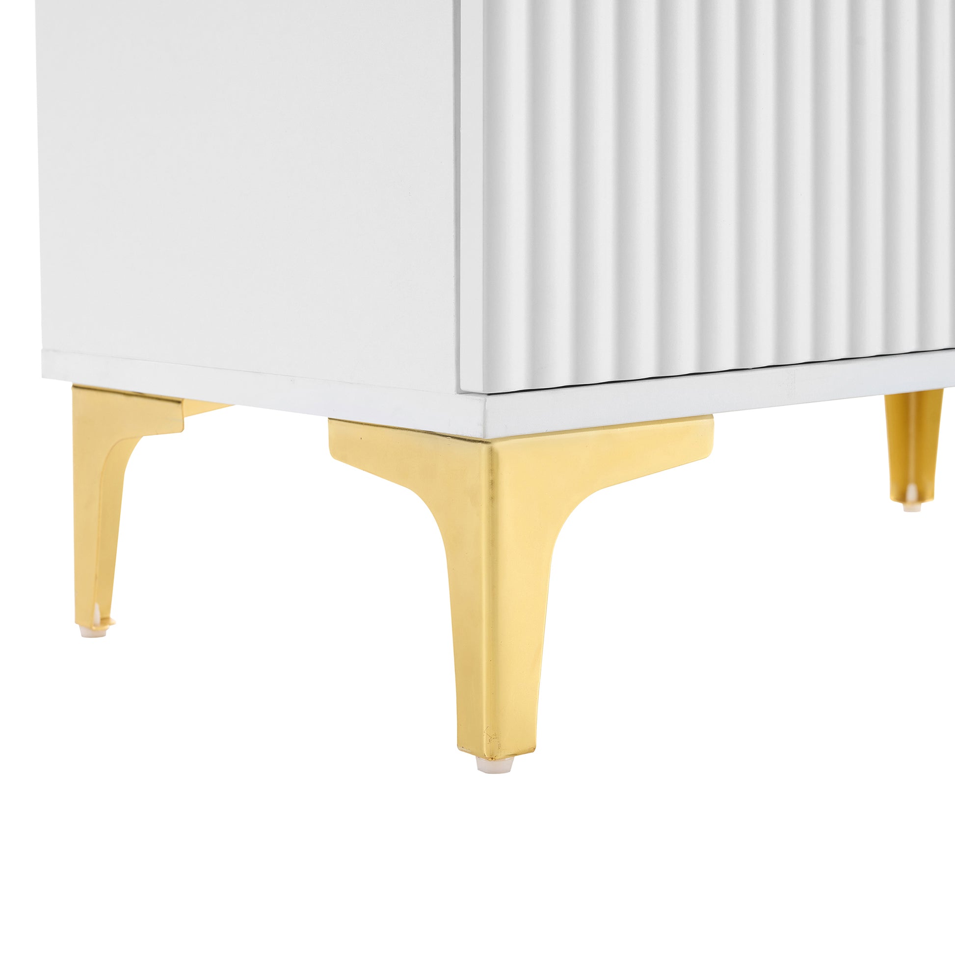 White cabinet detail with fluted texture and angled gold legs