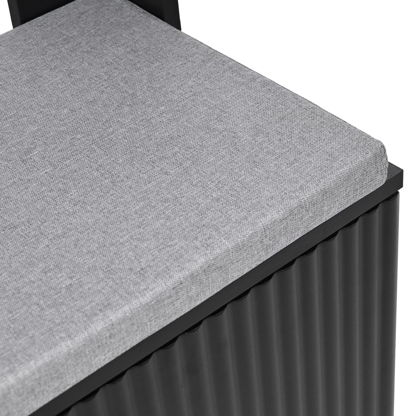 Grey upholstered storage ottoman with black corrugated base