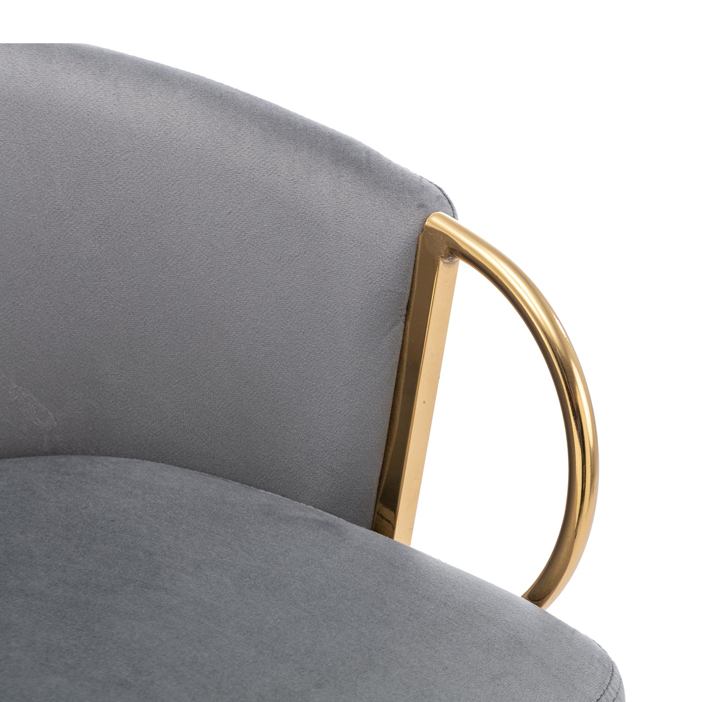 Close up of grey velvet accent chair with gold metal armrest detail