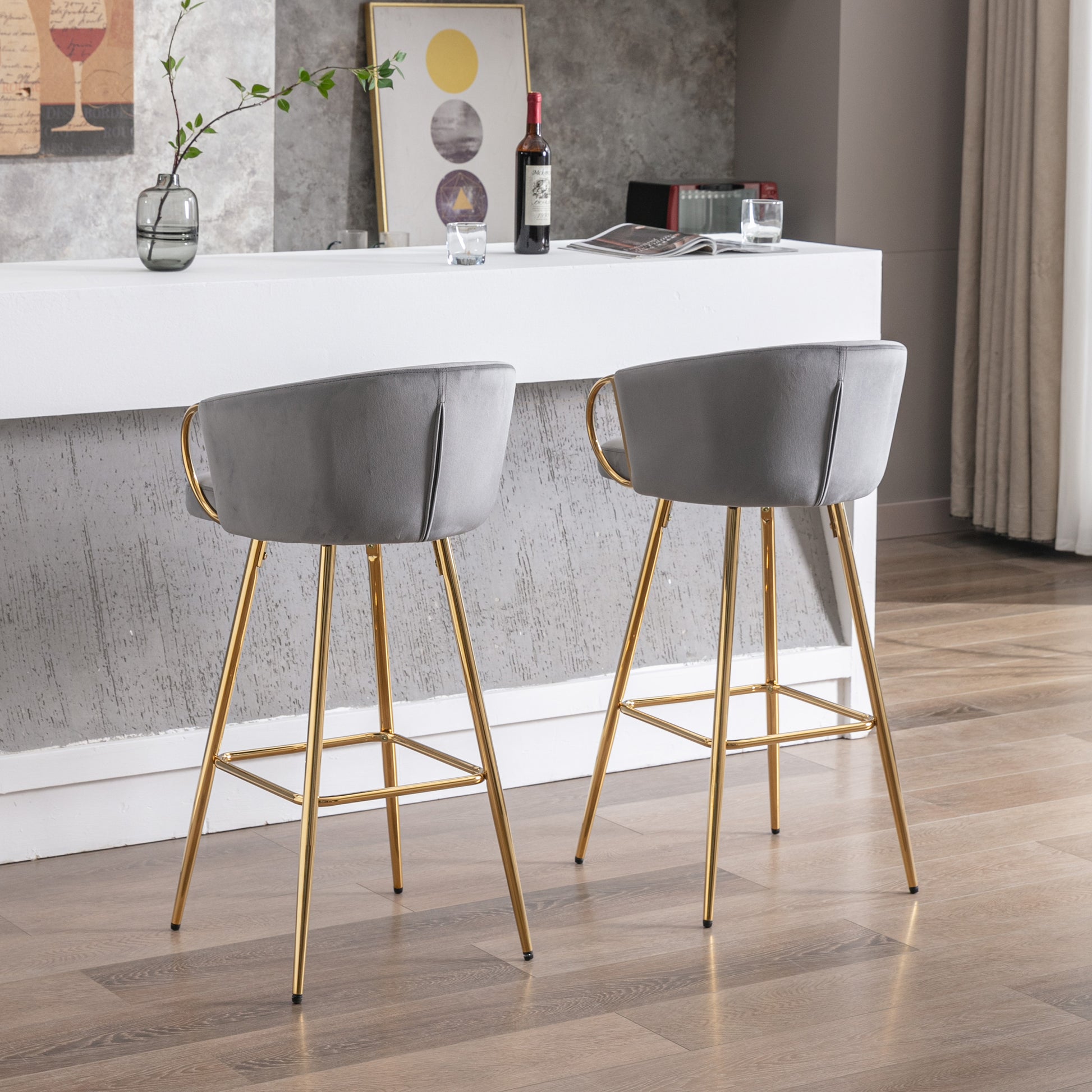 Grey velvet bar stool with curved back and gold legs perfect for a modern kitchen island