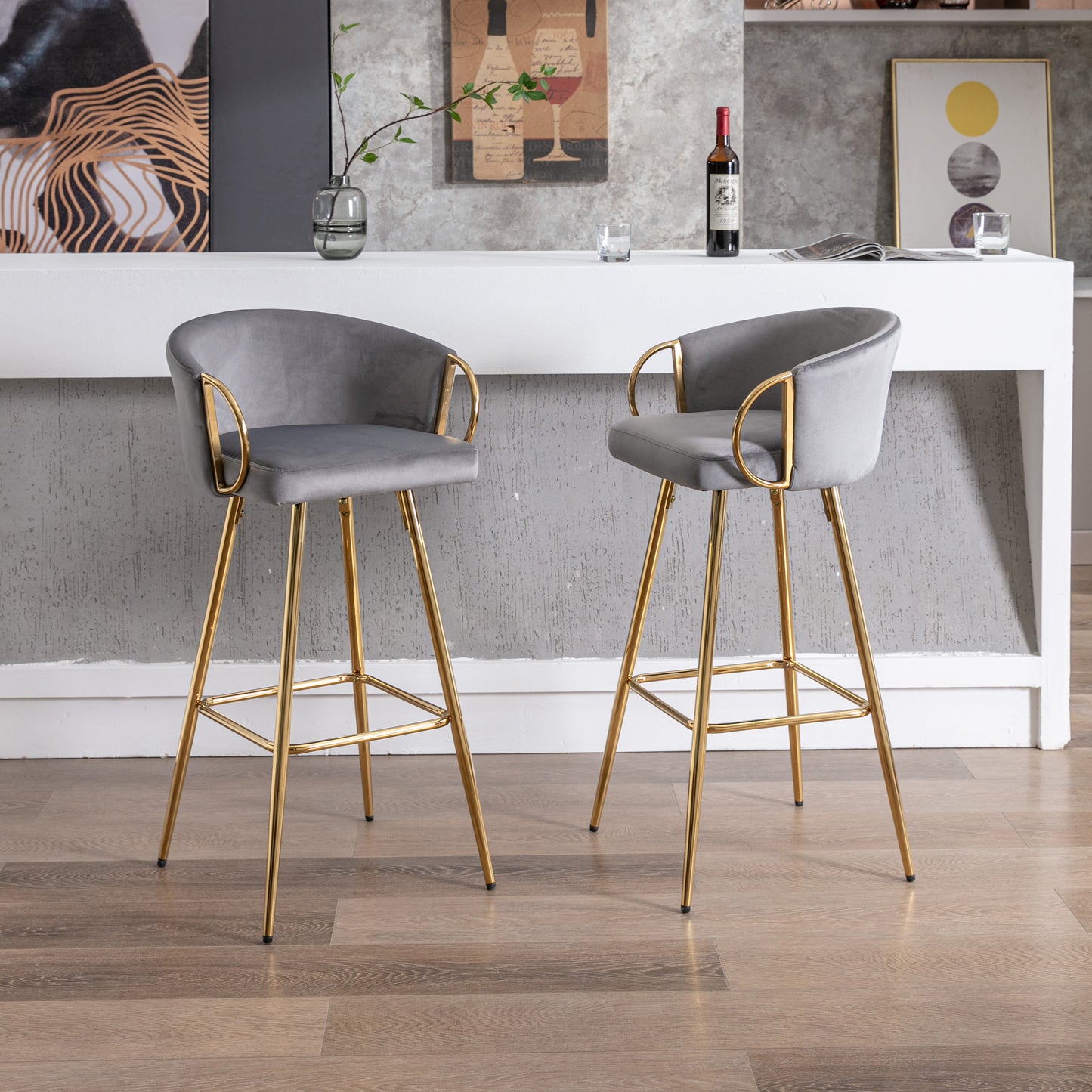 Grey velvet bar stool with gold legs and armrest accent