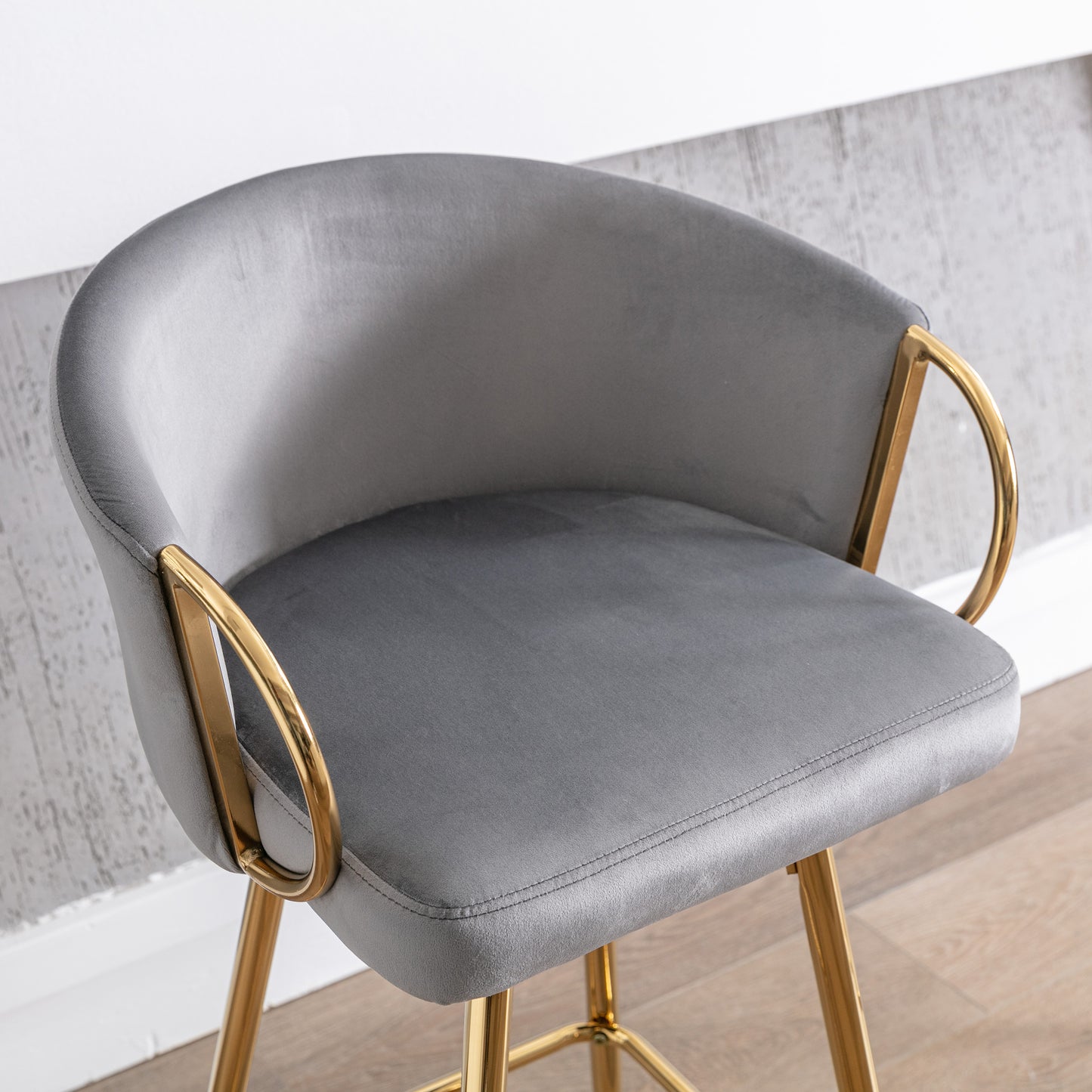 Grey velvet bar stool with curved back and gold legs