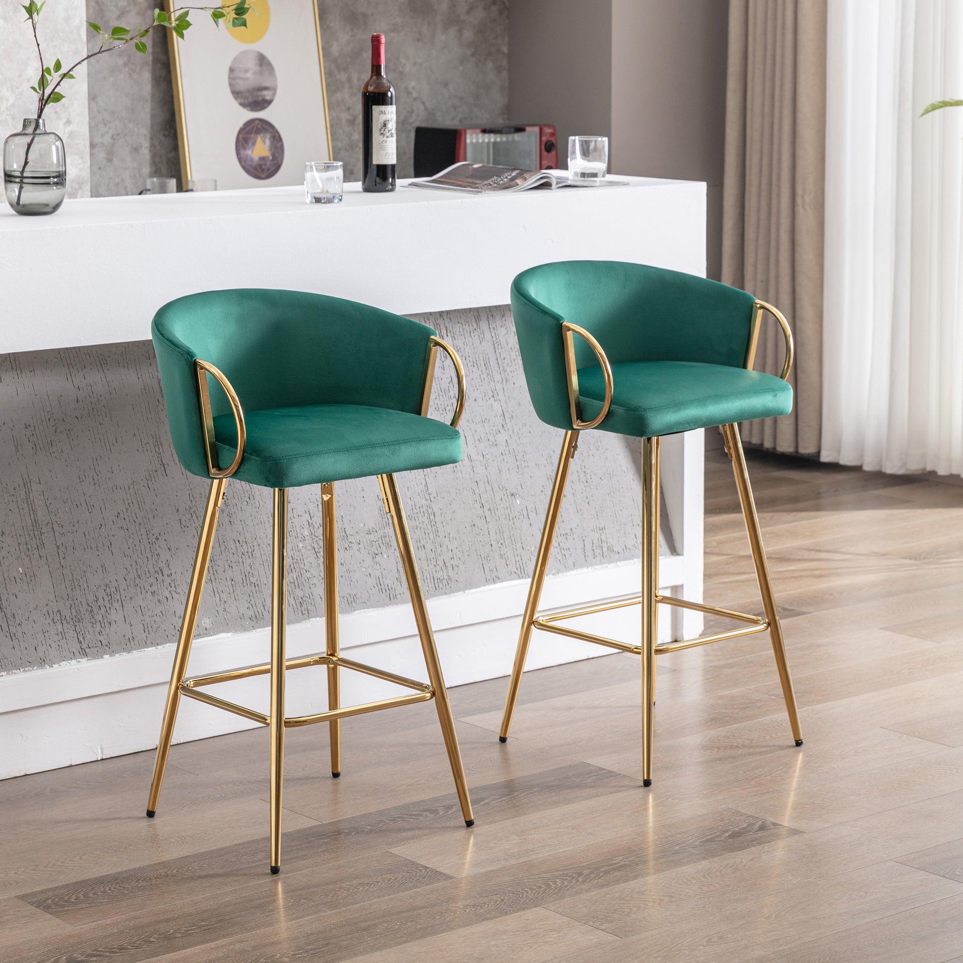 Emerald green velvet bar stool with gold legs and curved arms
