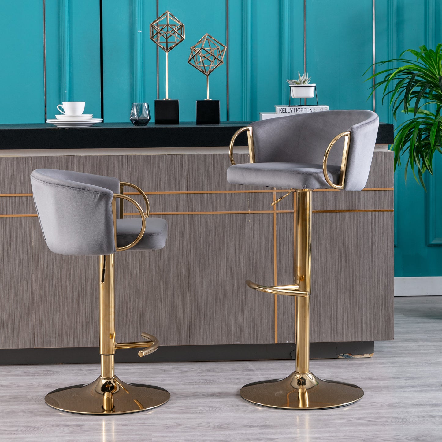 Gray velvet bar stool with gold base and armrests