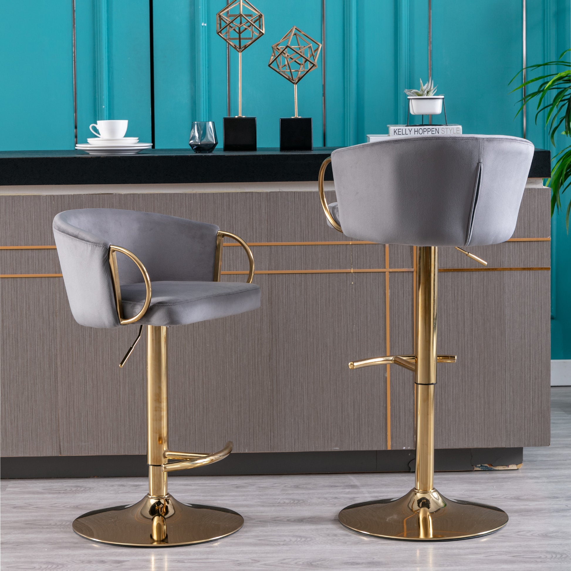 Gray velvet bar stool with gold adjustable base and curved armrests