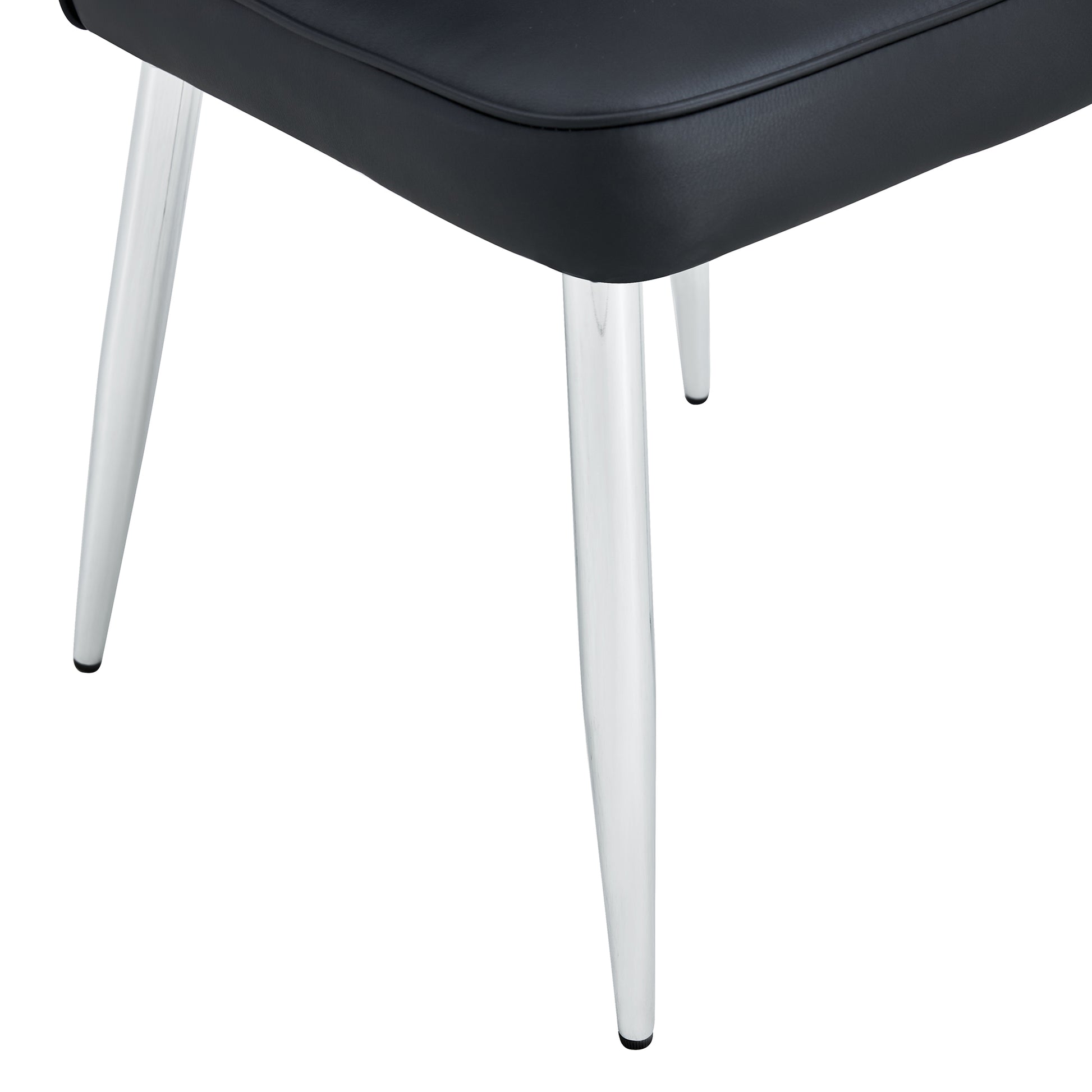 Closeup of black faux leather chair seat with chrome metal legs