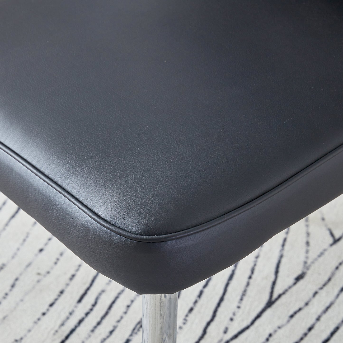 Black faux leather bar stool seat with chrome base