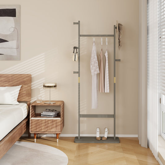 Modern grey metal garment rack with hanging dresses and beige handbag