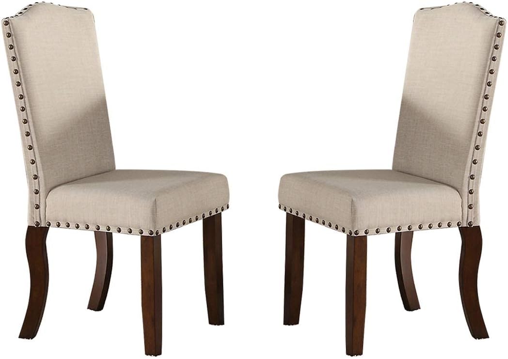 Pair of cream linen dining chairs with nailhead trim and dark wood legs