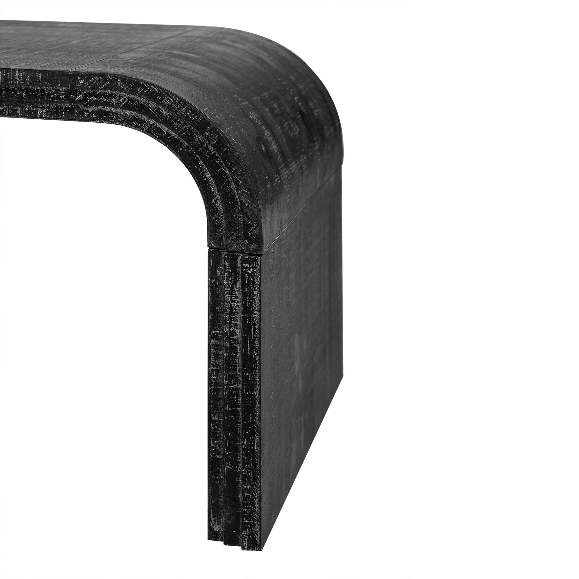 Closeup of a black carved wood sculptural bench