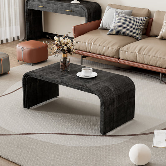 Dark wood curved coffee table with a cup of coffee