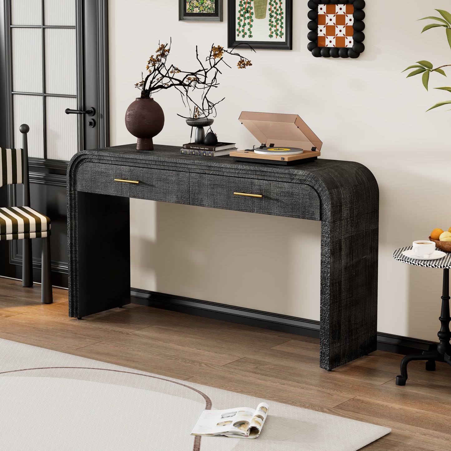 Dark gray textured console table with gold drawer pulls and curved edges