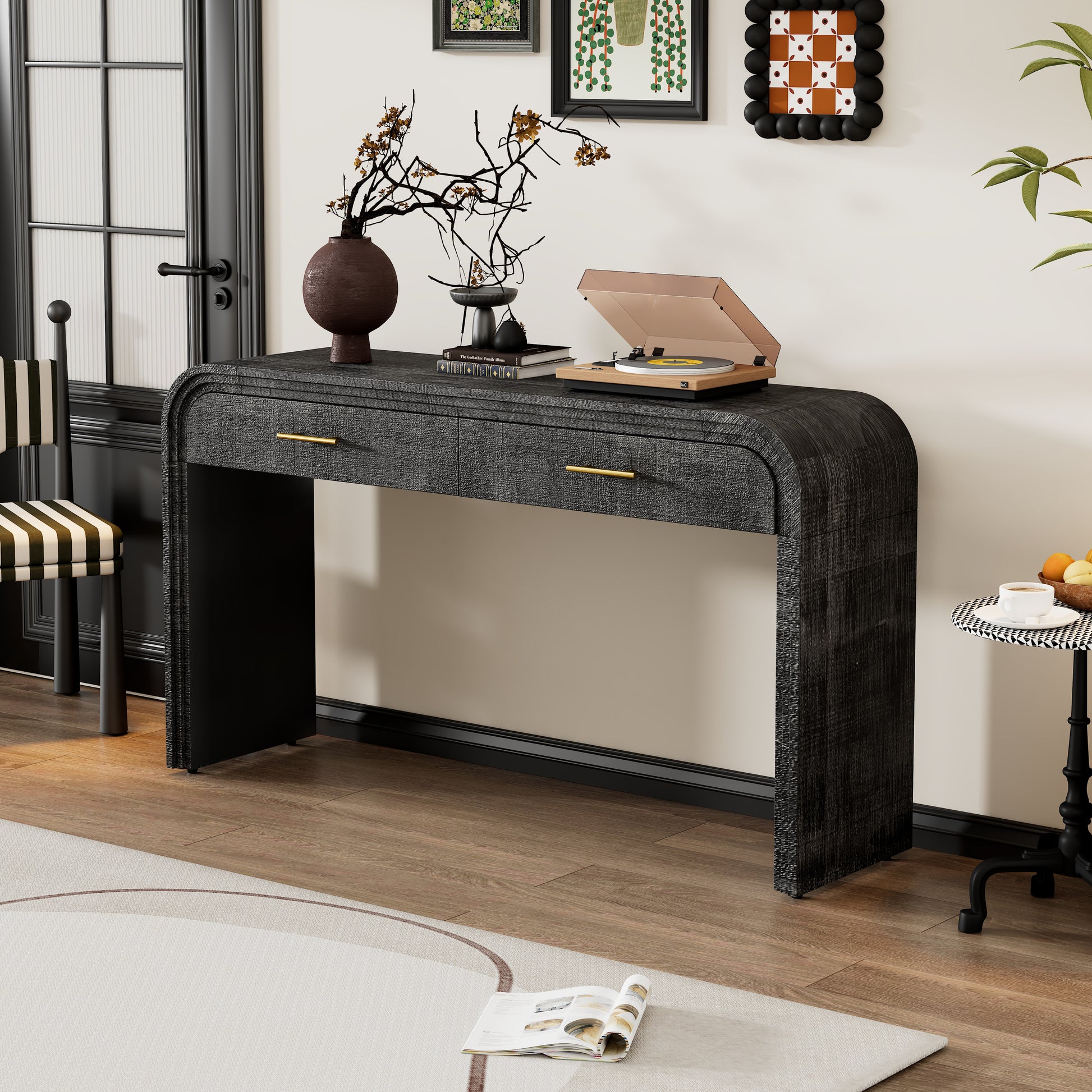 Dark gray textured console table with gold drawer pulls and curved edges