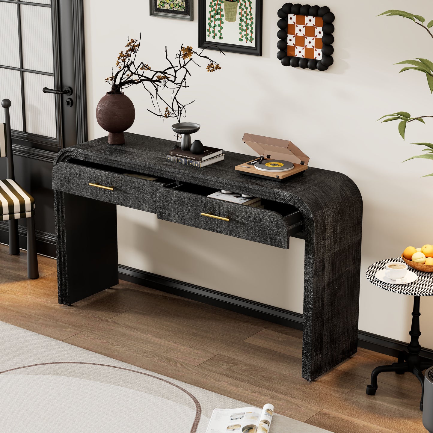 Black textured console table with curved ends and gold drawer pulls
