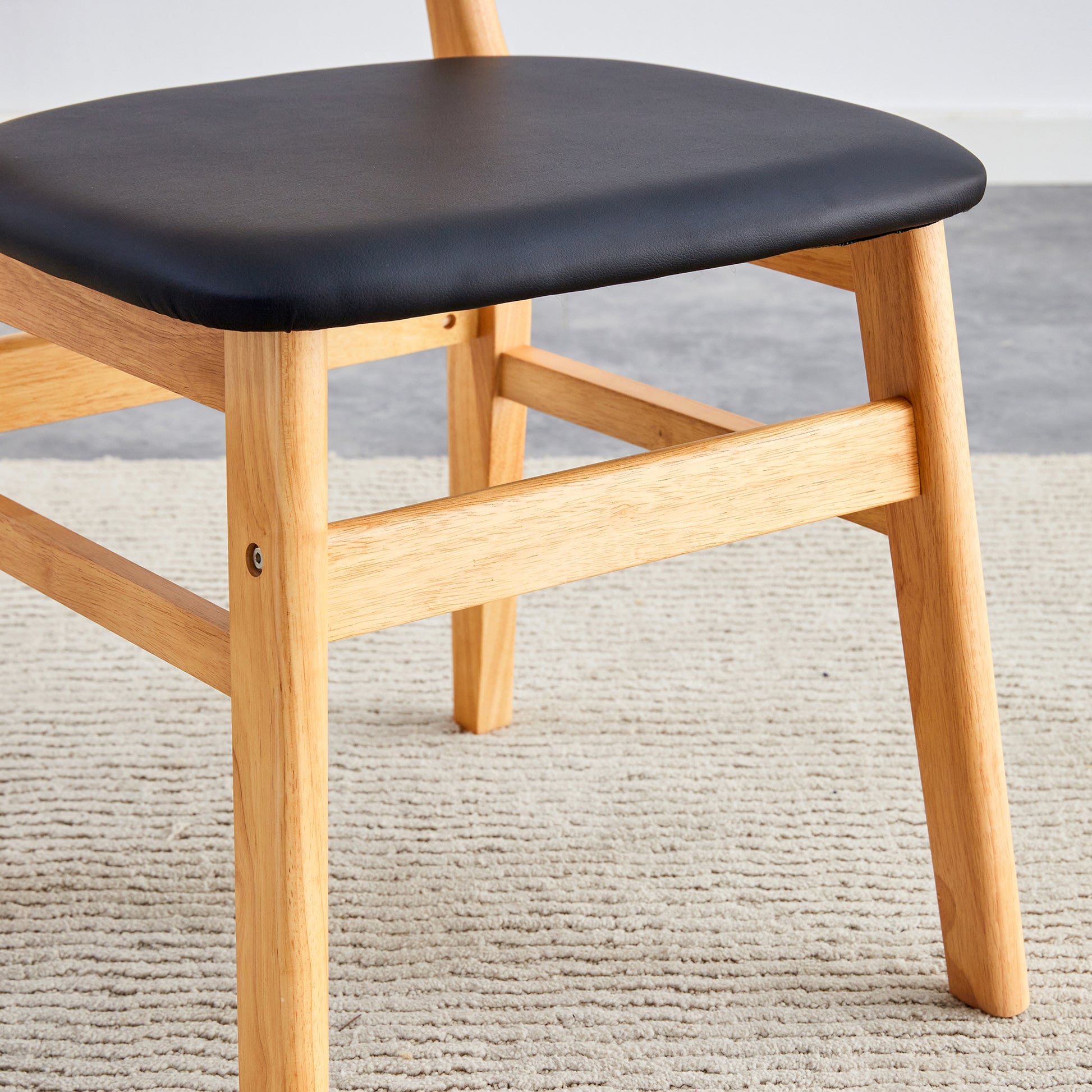 Black upholstered wooden dining chair seat and legs