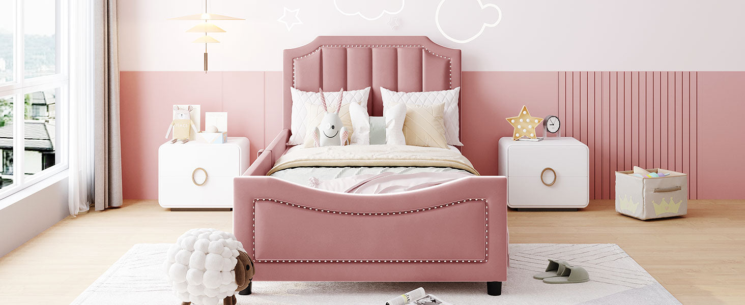 Pink velvet twin bed with studded headboard and footboard perfect for a childs bedroom