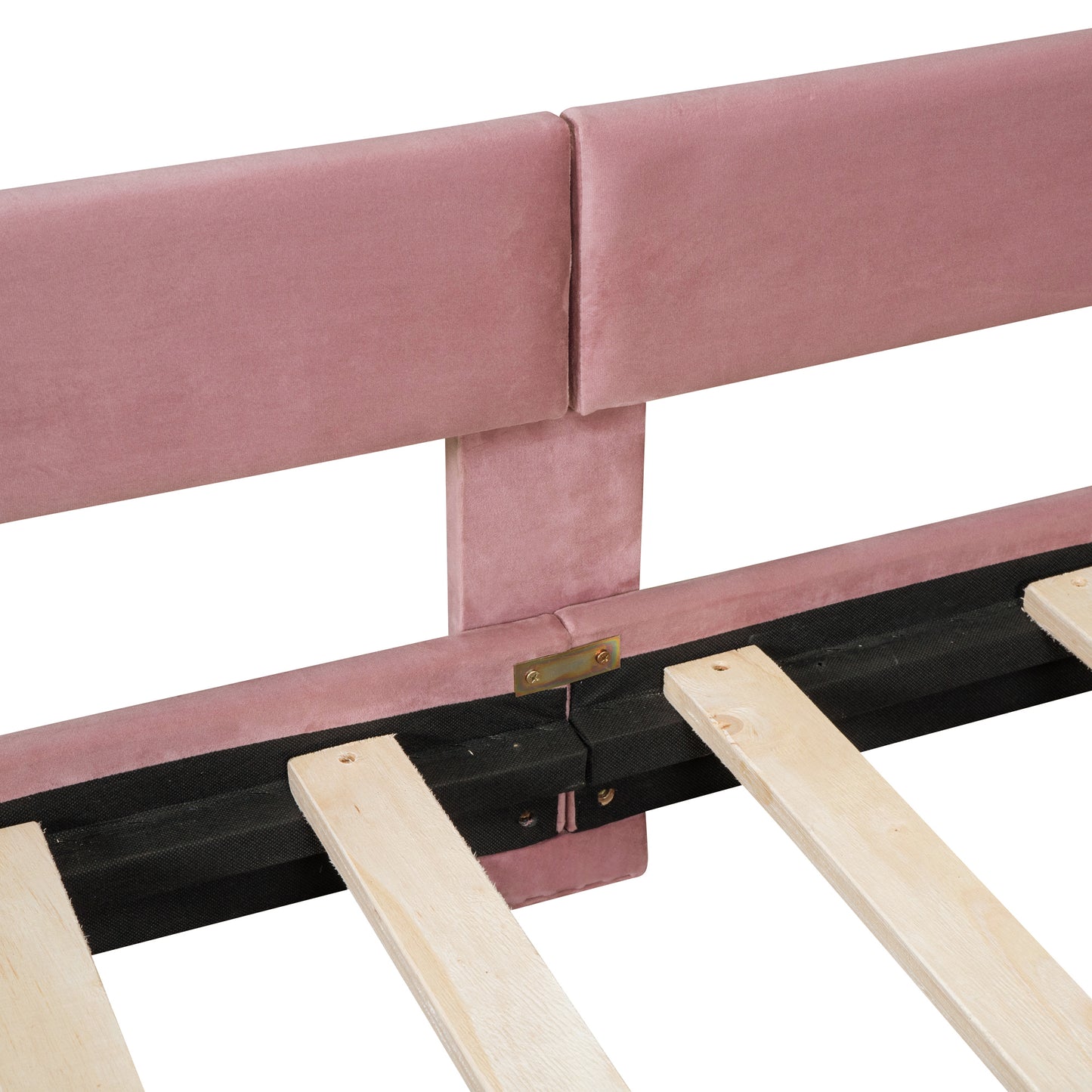 Close up of pink velvet headboard upholstery and wooden bed slats