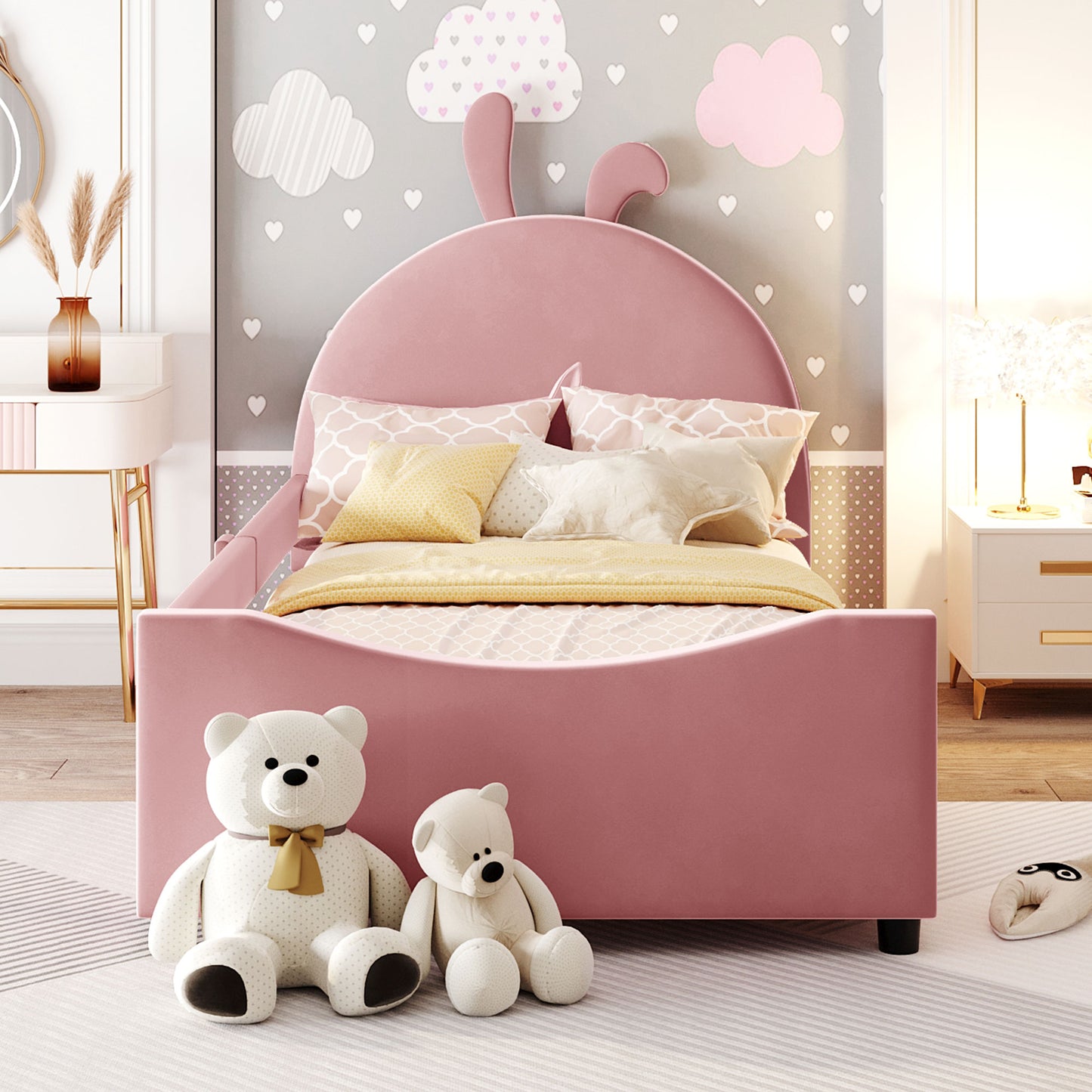 Pink velvet twin bed with bunny ears headboard and decorative pillows